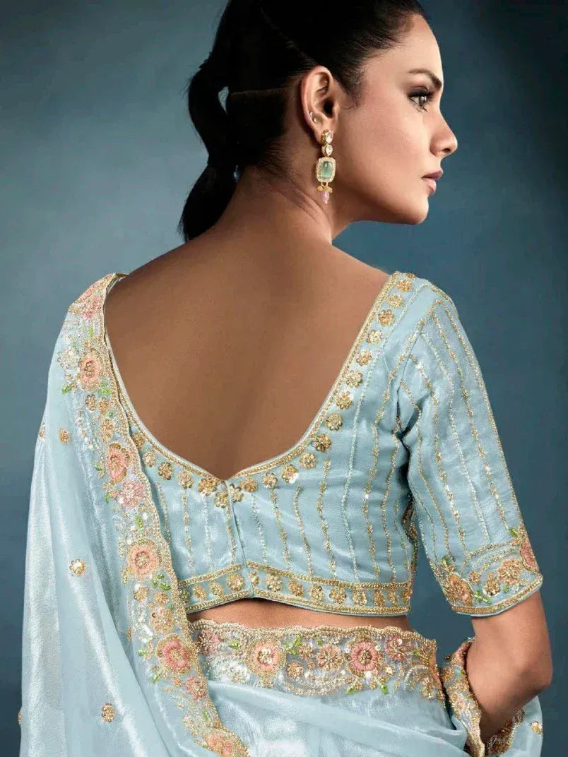 Light blue designer lehenga choli with floral embroidery and gold detailing, perfect for ethnic occasions