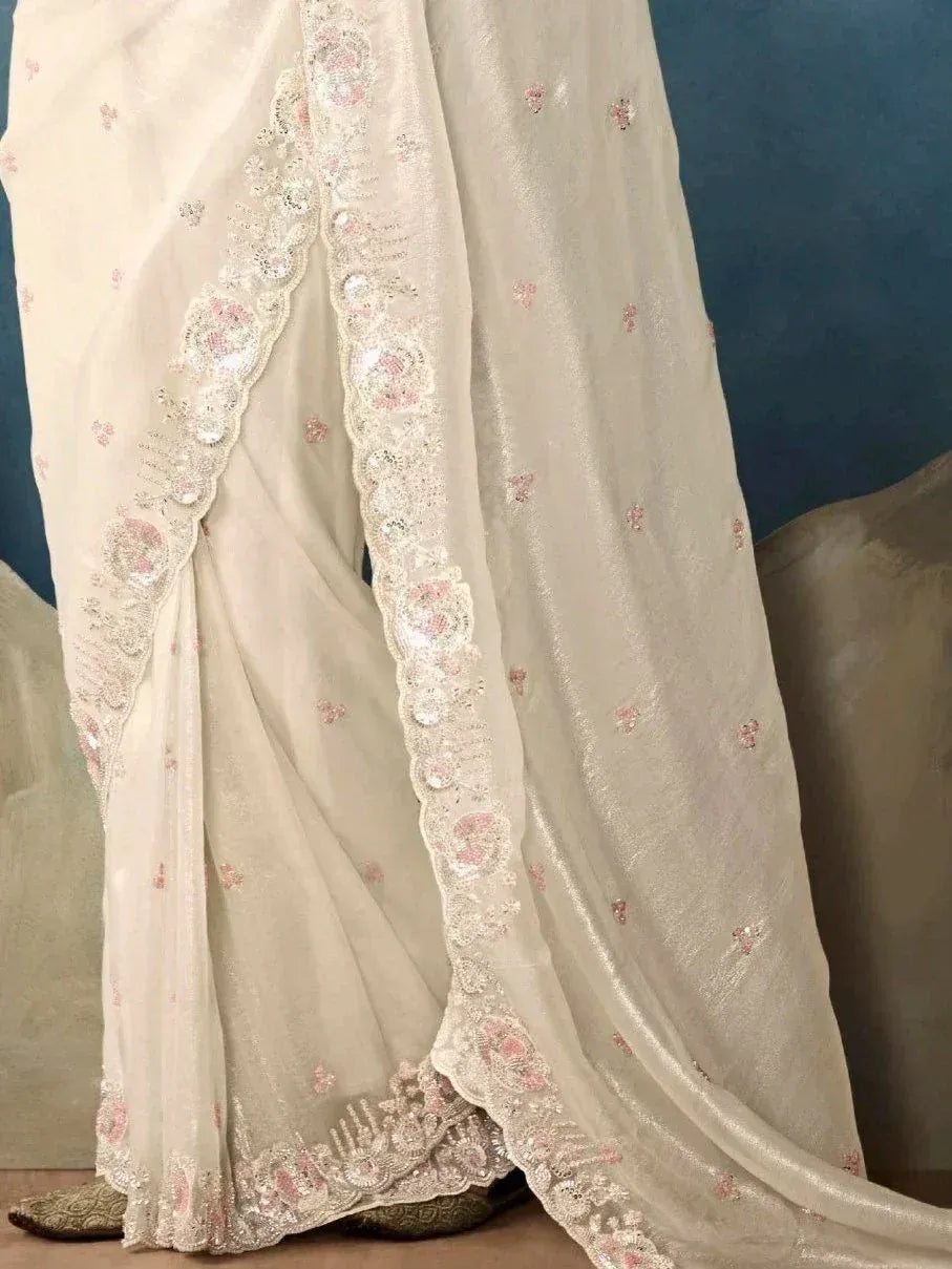 Elegant ivory saree with pink floral embroidery and lace border, perfect for Indian ethnic wear
