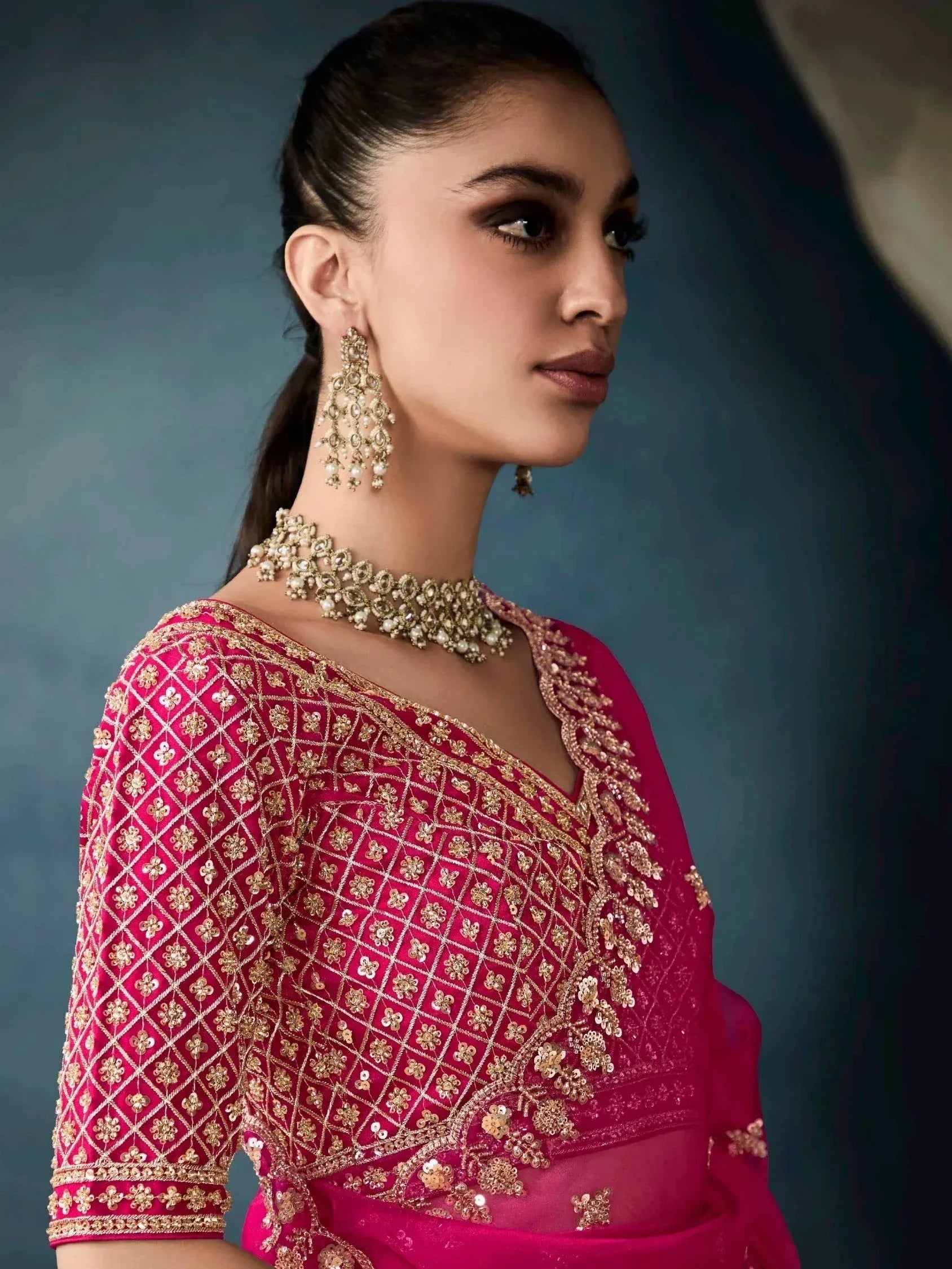 Elegant pink Indian ethnic wear with gold embroidery, perfect for weddings and festive occasions.