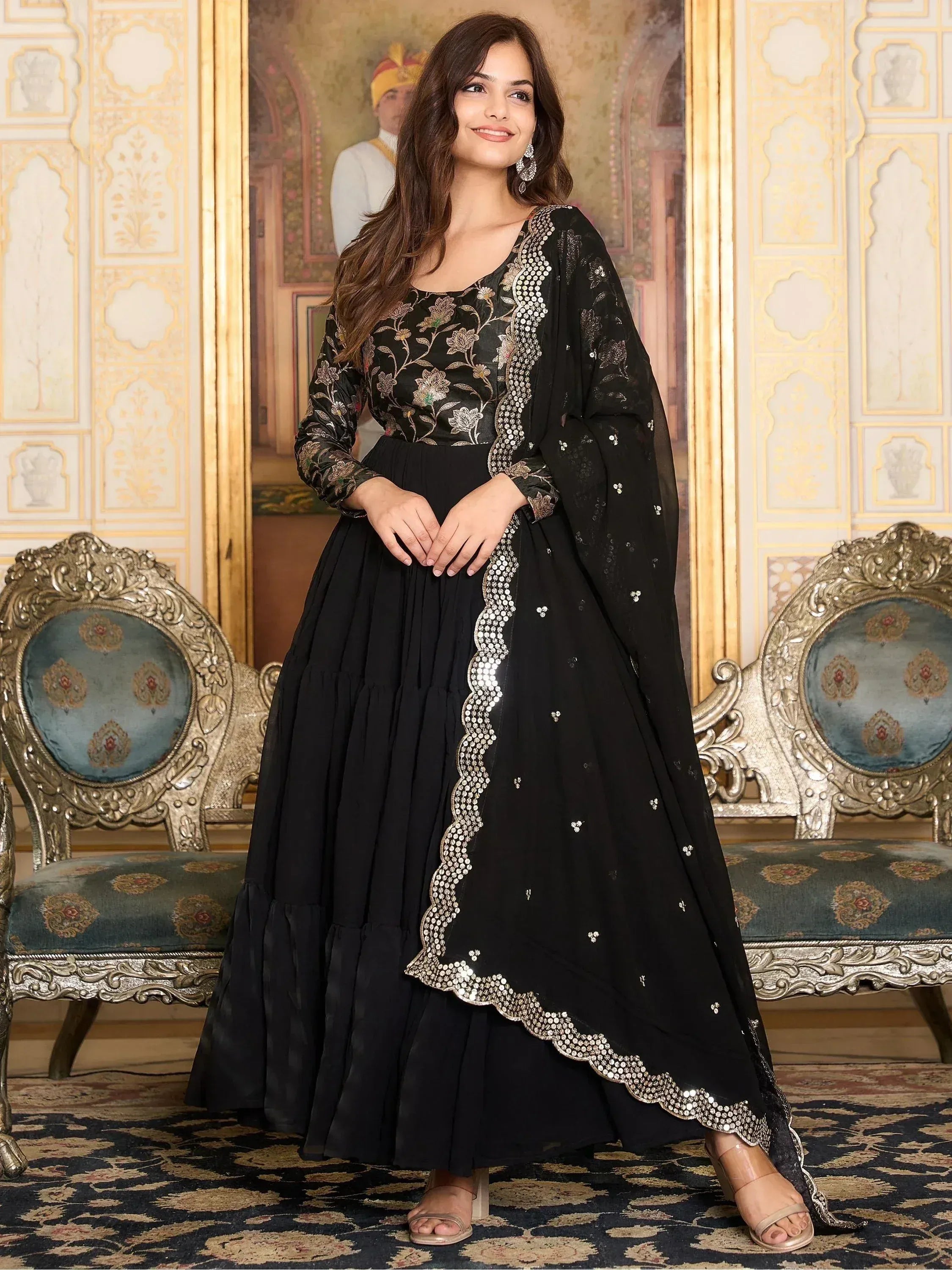 Black embroidered ethnic gown with floral designs and sequin detailing, perfect for festive occasions.