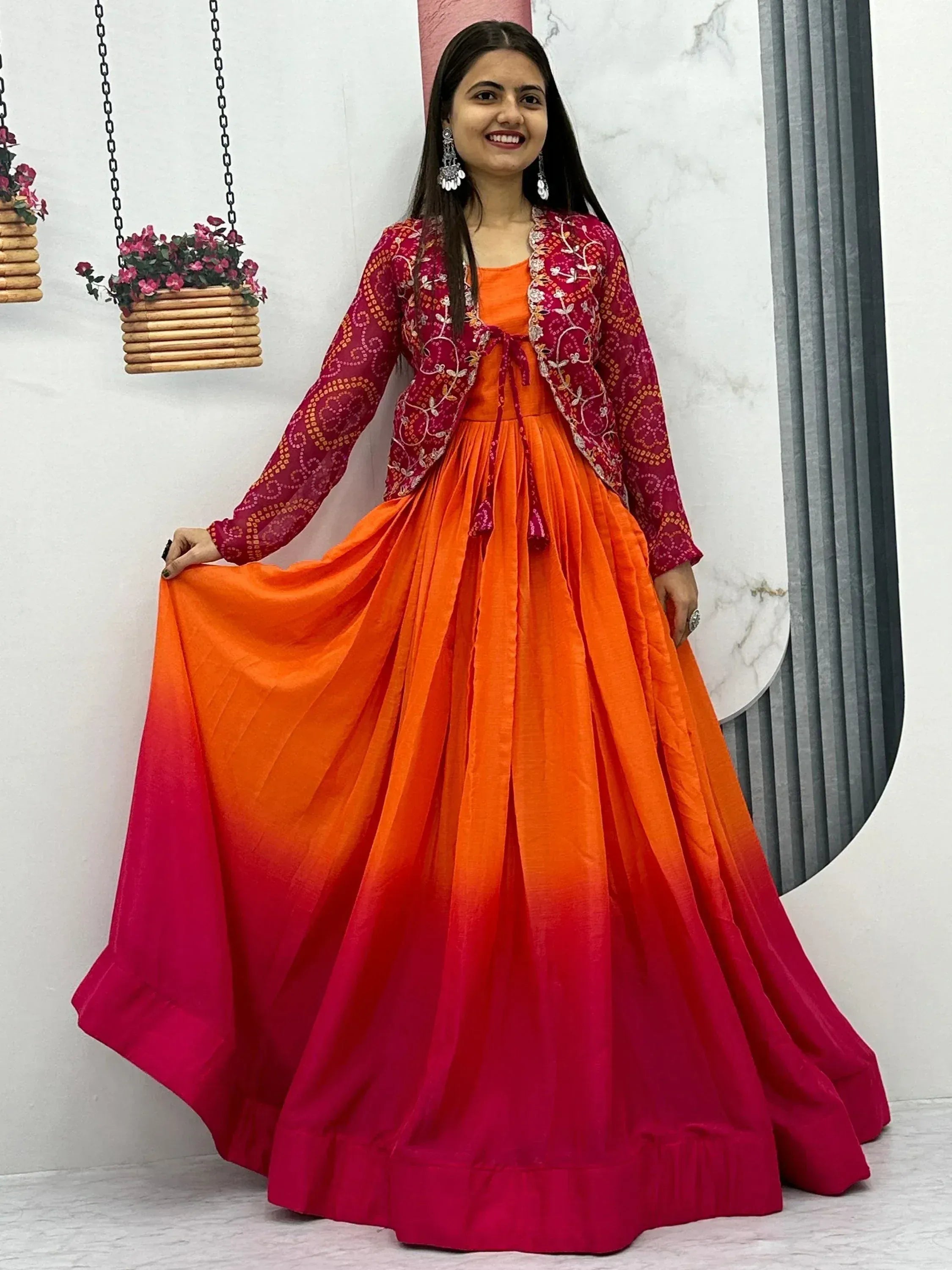 Vibrant orange to pink ombre ethnic gown with embroidered magenta jacket, perfect for festive occasions.