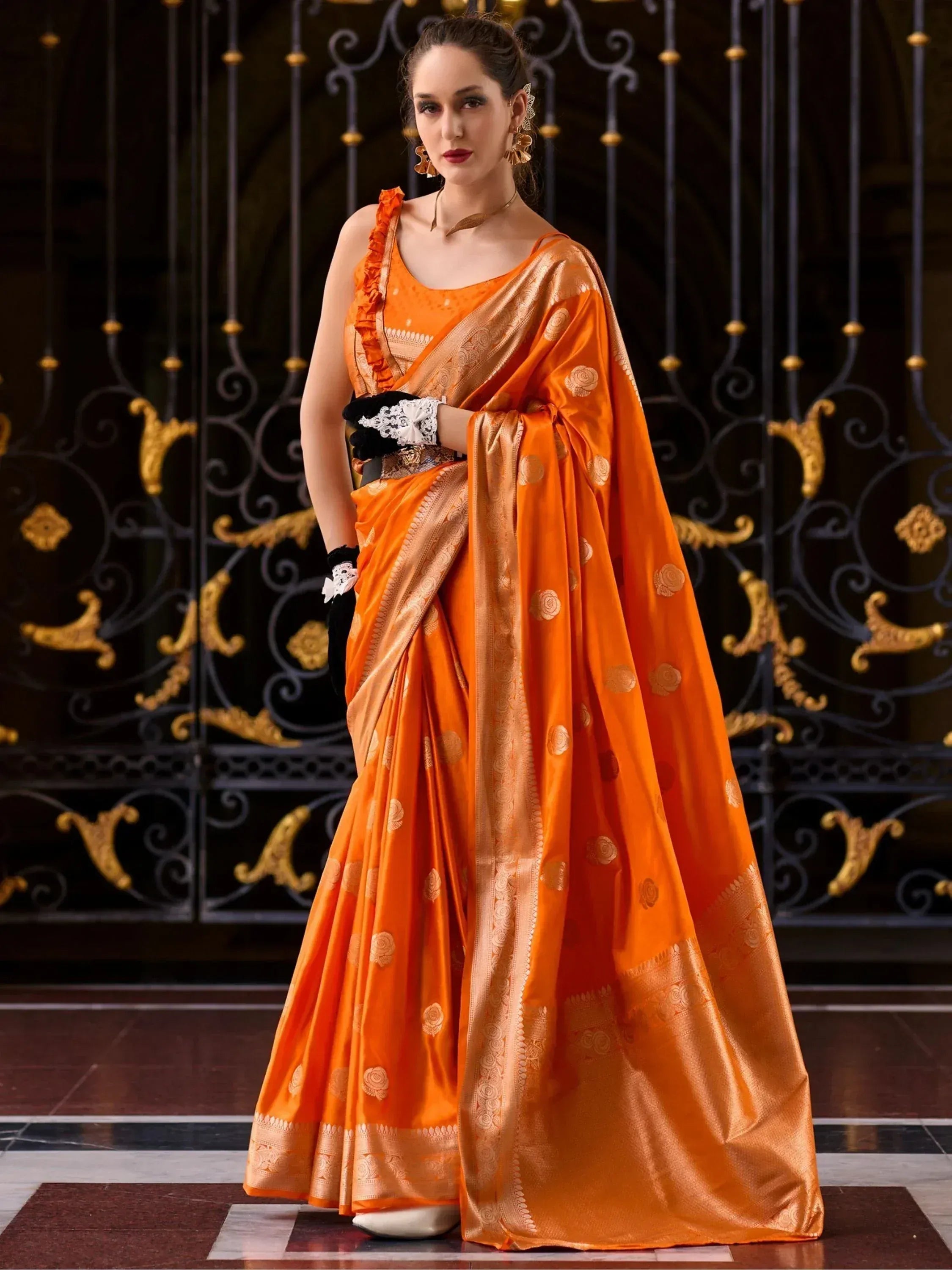 Orange designer saree with gold motifs, perfect for Indian ethnic wear events