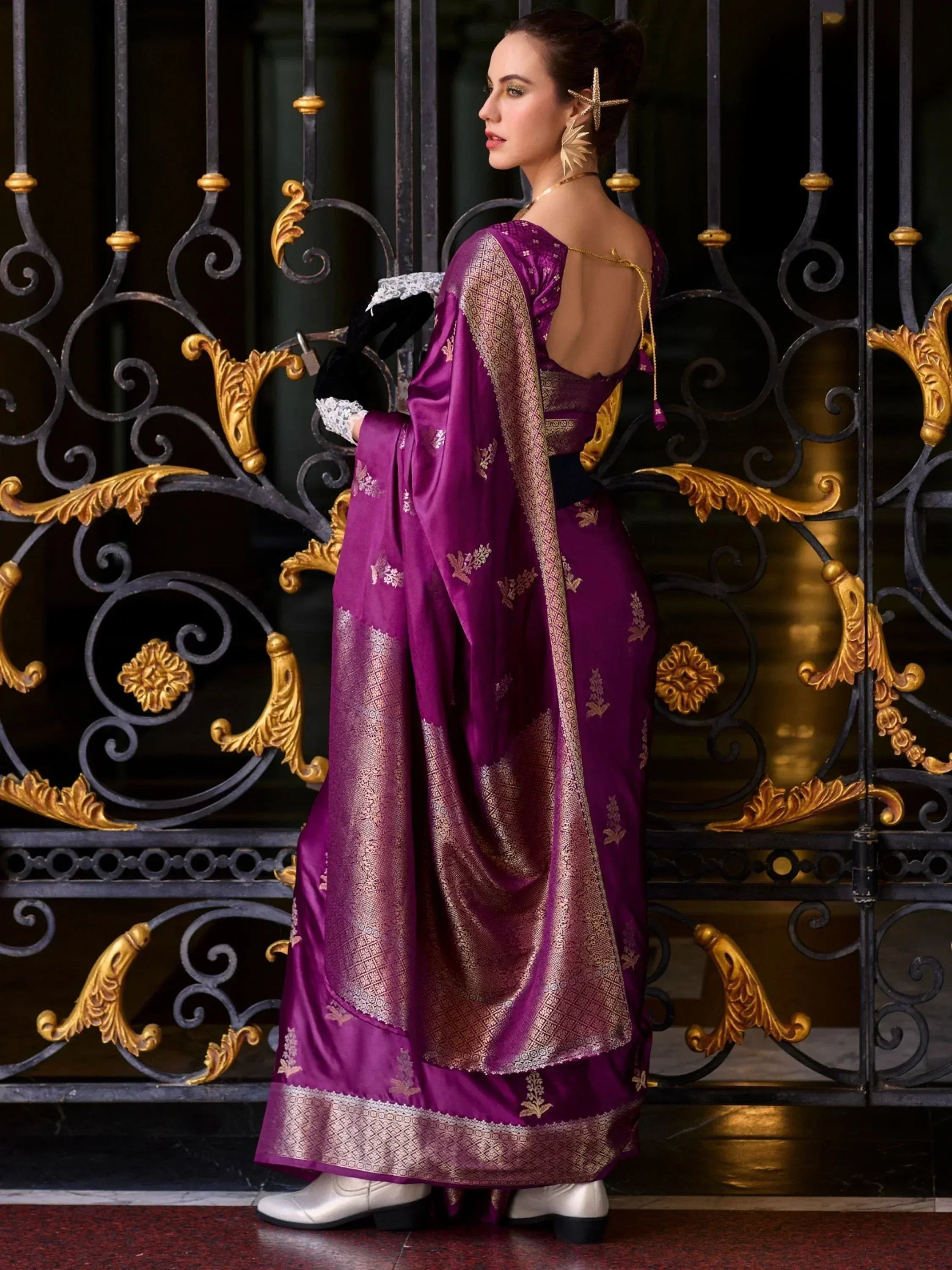 Purple designer saree with gold embroidery, backless blouse, and lace gloves for ethnic wear