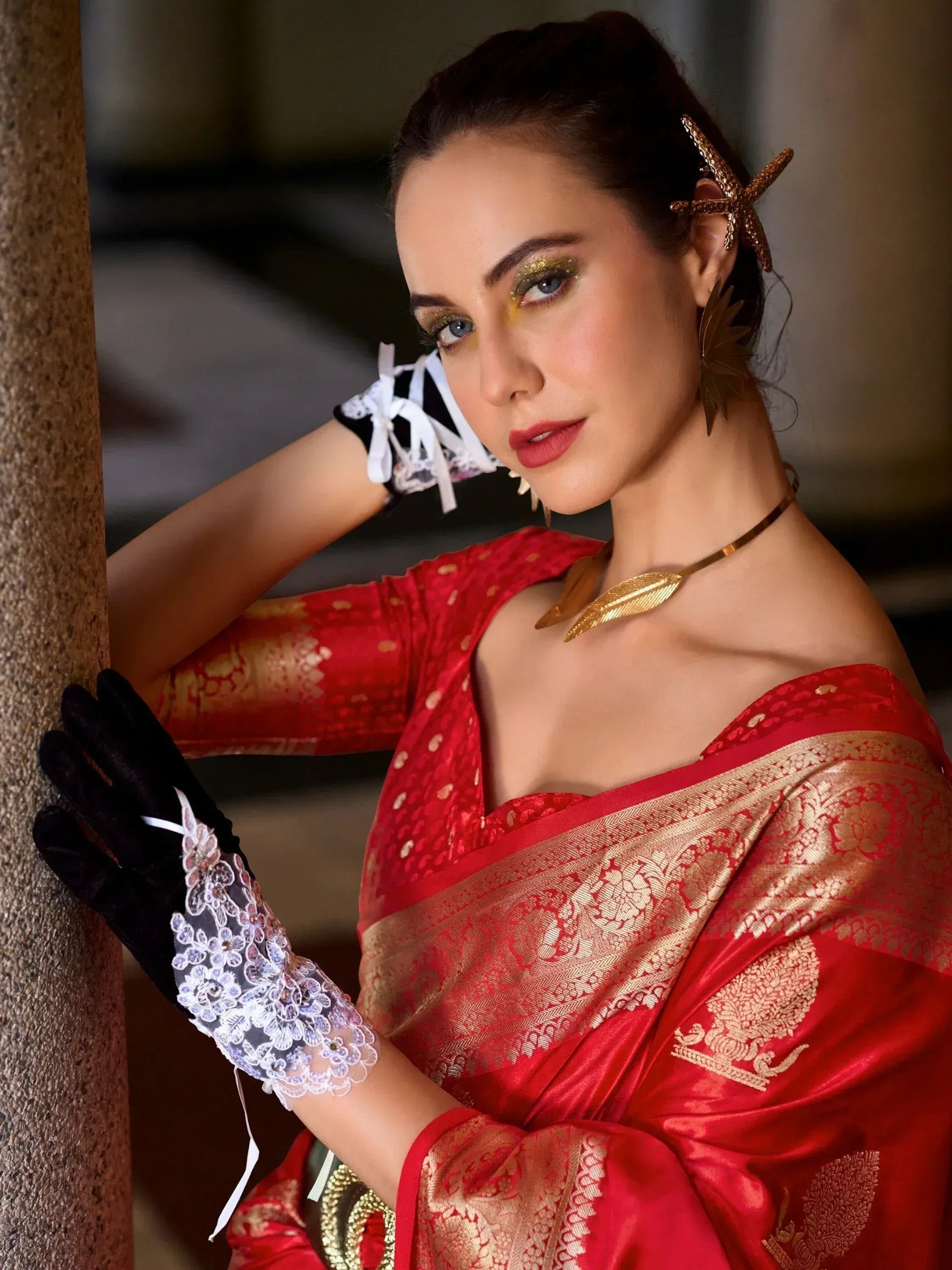 Woman in red and gold ethnic saree with lace gloves and starfish hair accessory