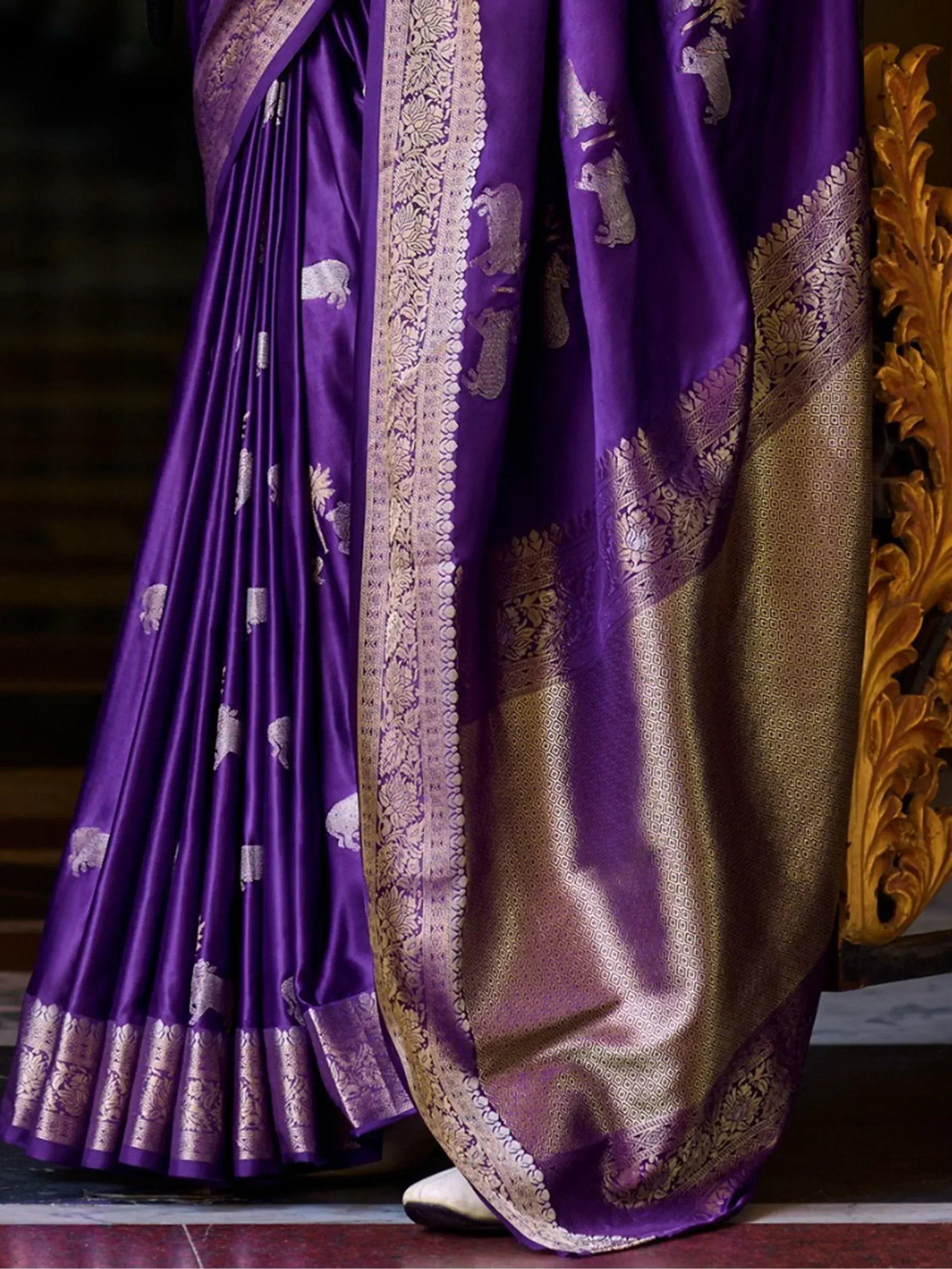 Purple silk saree with gold elephant motifs and intricate border, ideal for Indian ethnic wear occasions