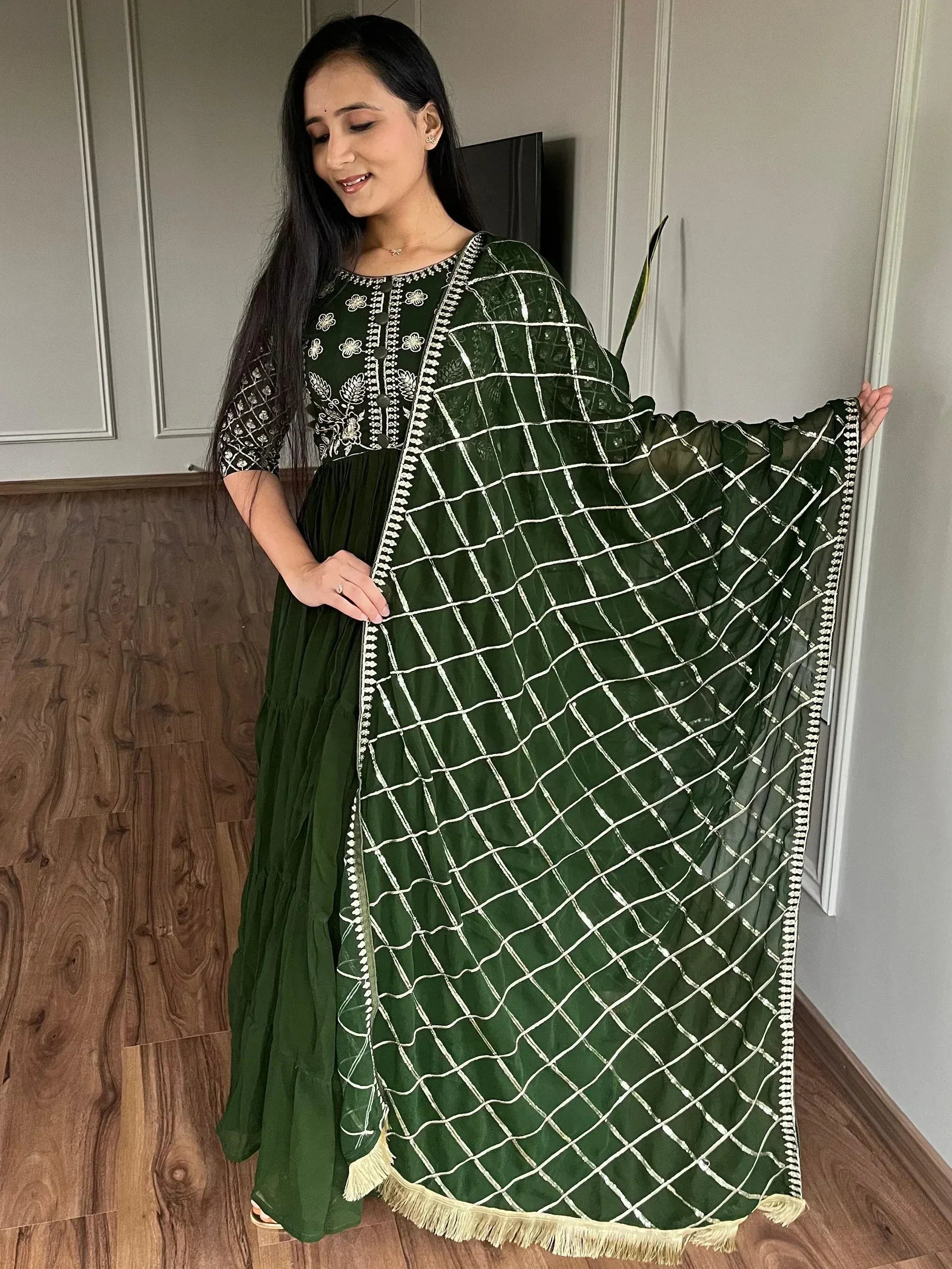 Green ethnic gown with white embroidery and net dupatta, perfect for Indian occasions