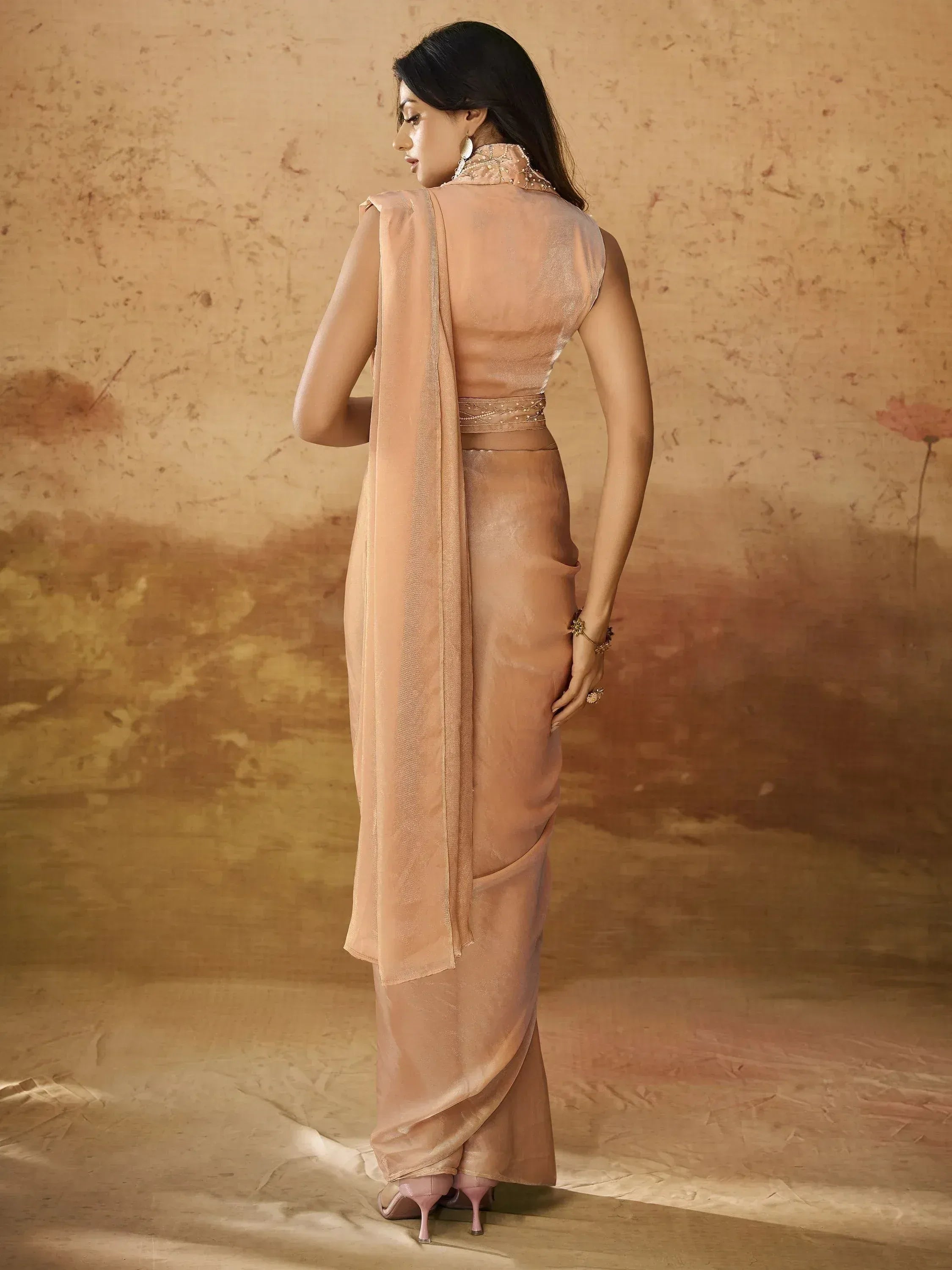 Woman in peach designer saree with embroidered blouse, ethnic wear for festive occasions