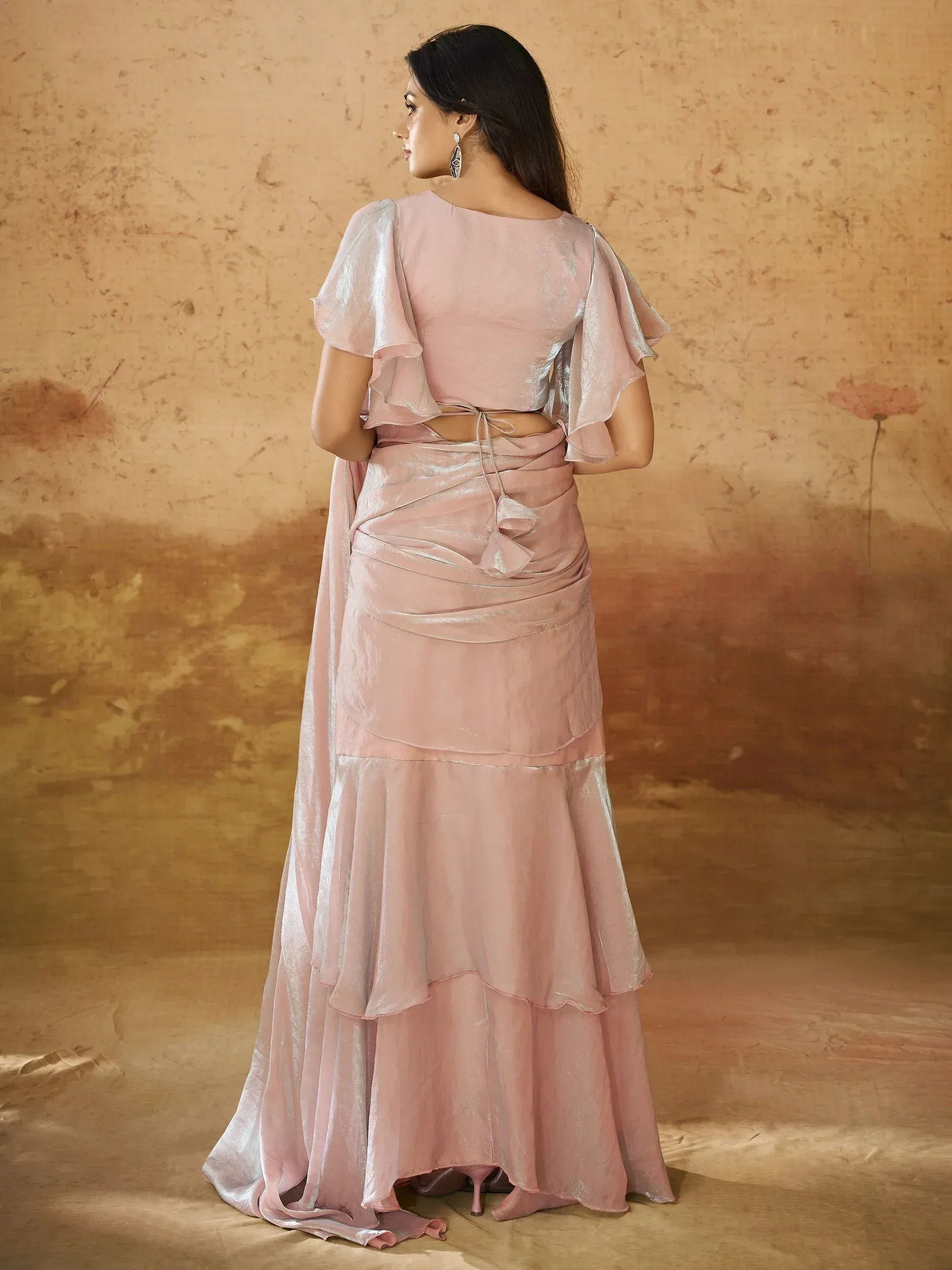 Pink ethnic gown with ruffled sleeves and layered skirt, perfect for Indian occasions