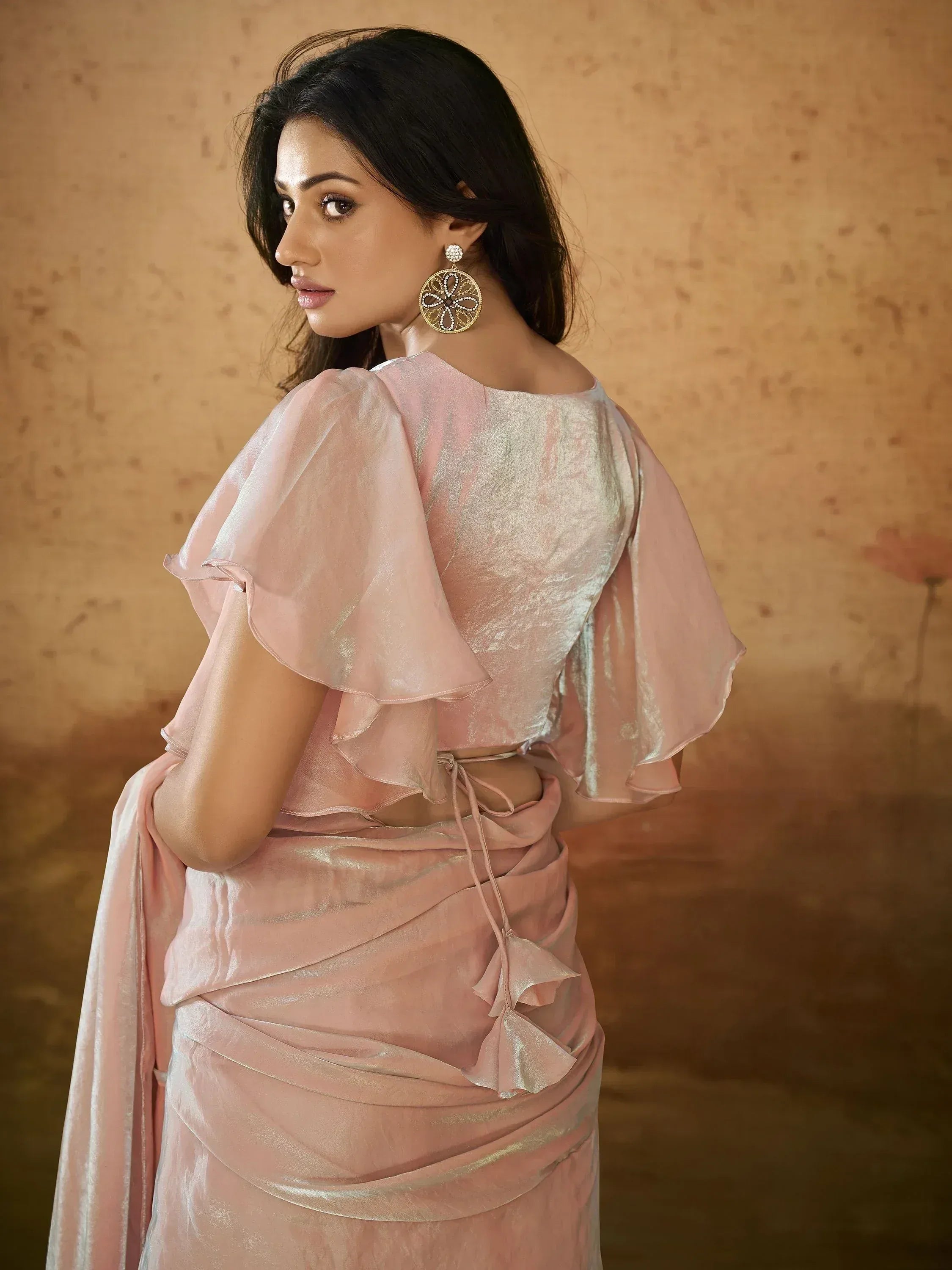 Pink ethnic gown with ruffled sleeves and back tie, perfect for Indian weddings or festive occasions.