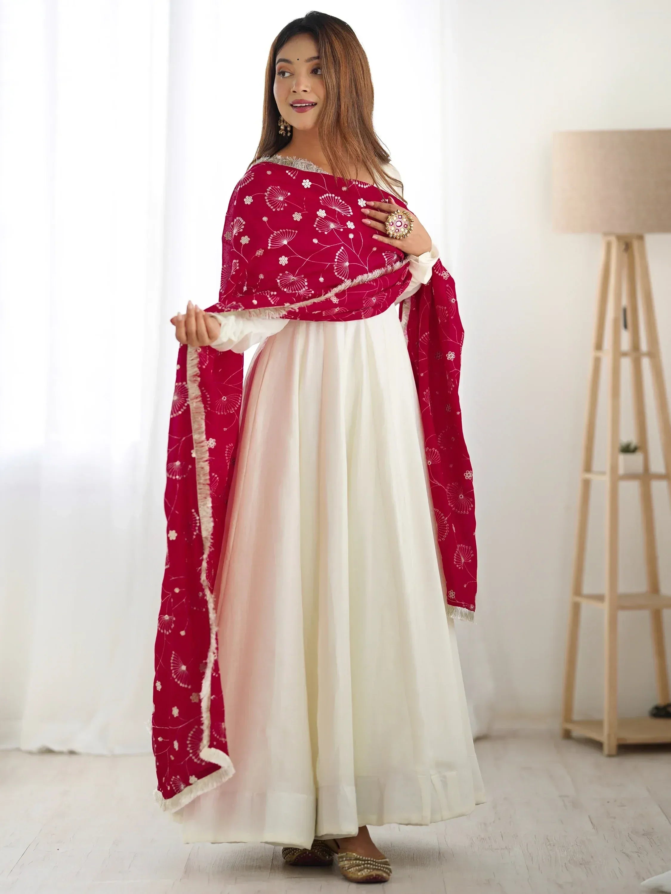 Woman in white ethnic gown with red embroidered dupatta, traditional Indian wear
