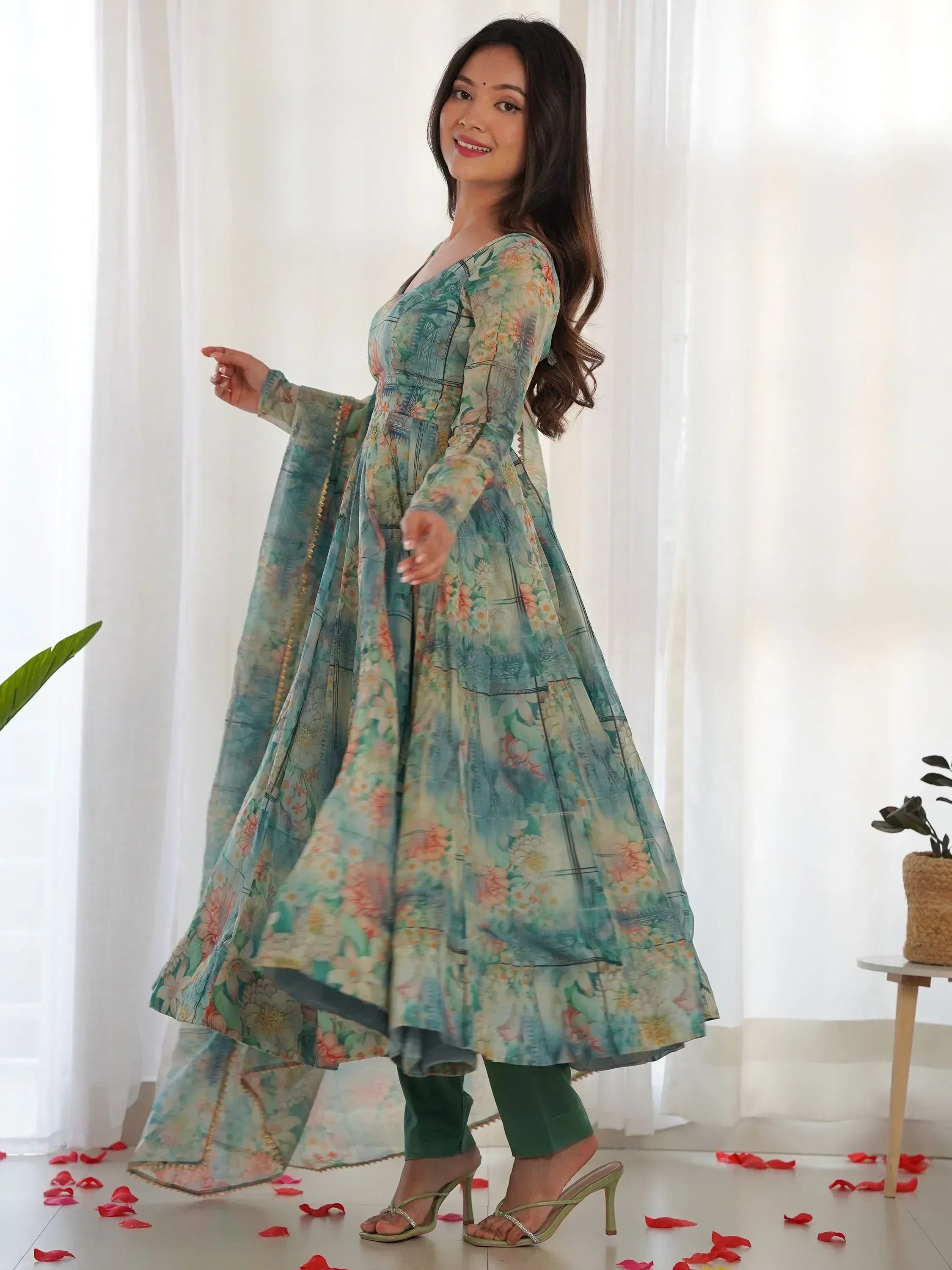 Woman in floral print ethnic anarkali gown with green pants, perfect for Indian occasions