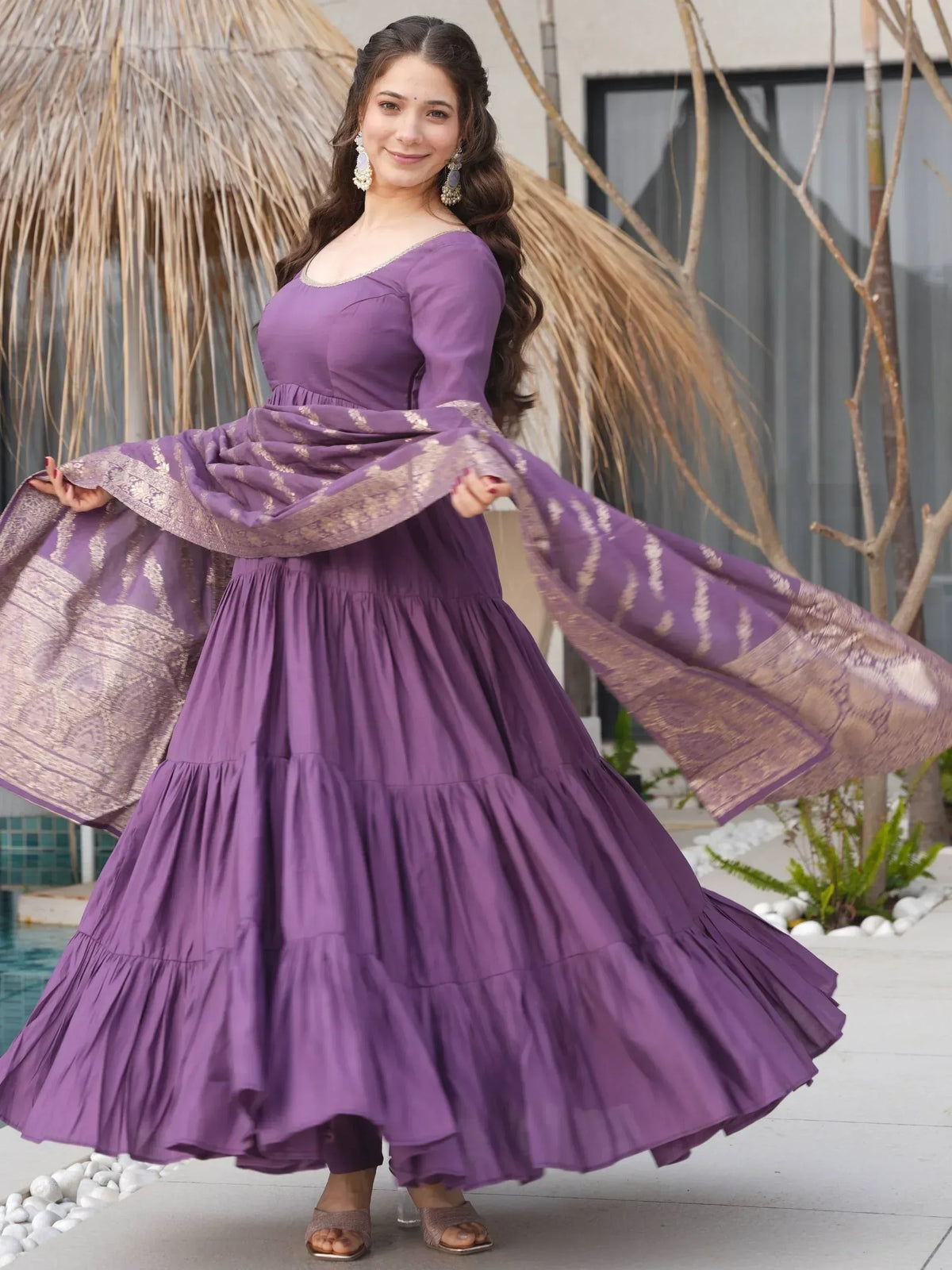 Purple tiered ethnic gown with gold woven dupatta, perfect for Indian occasions and festive wear.