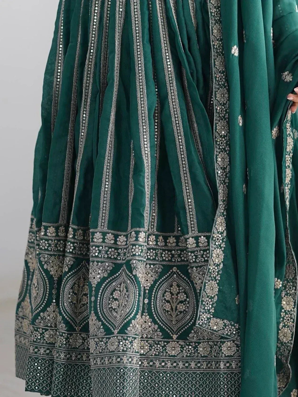 Emerald green ethnic lehenga with silver embroidery and mirror work, perfect for Indian weddings and festive occasions.