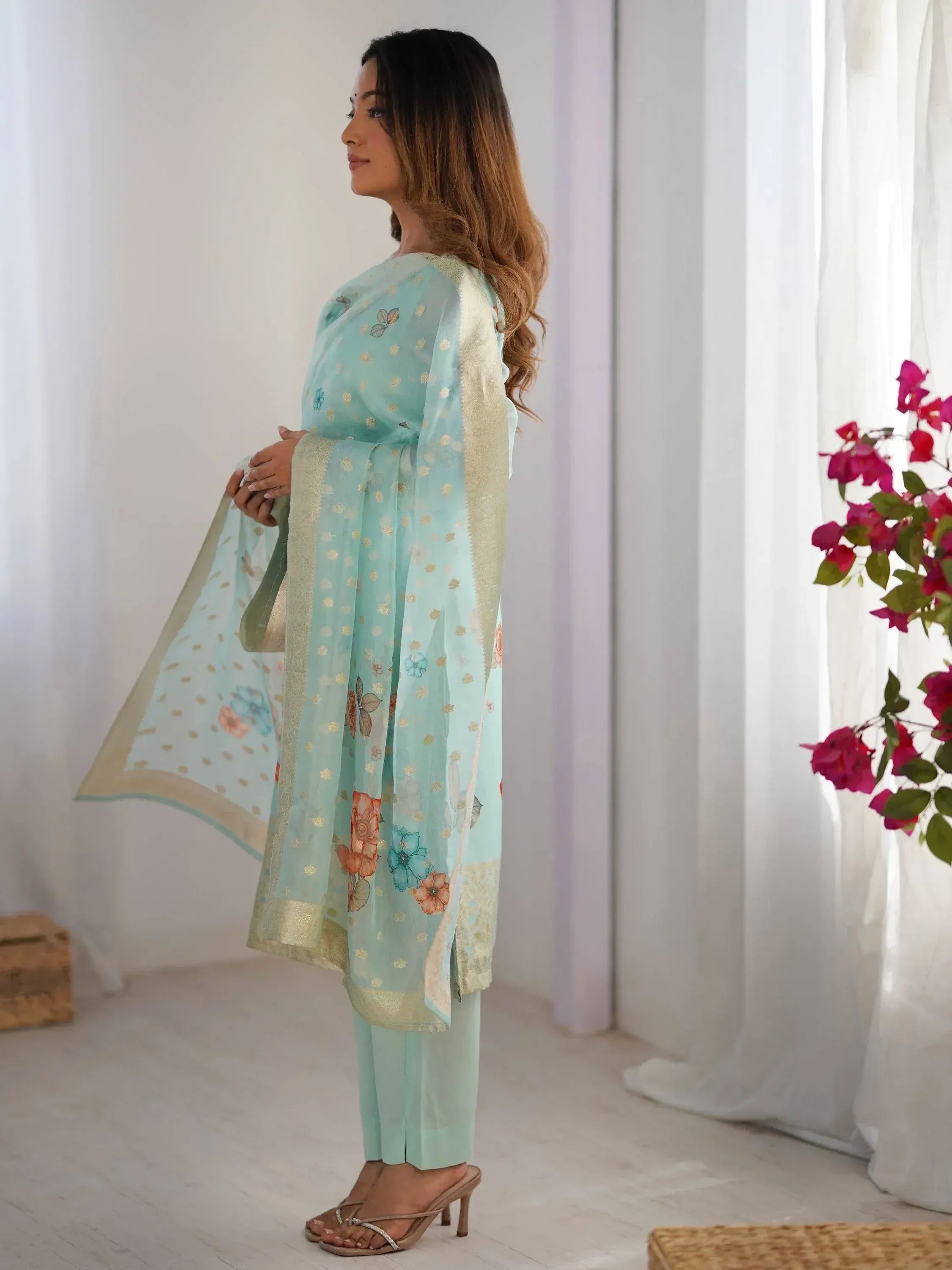 Woman in mint green floral salwar kameez with gold border, ethnic wear for women