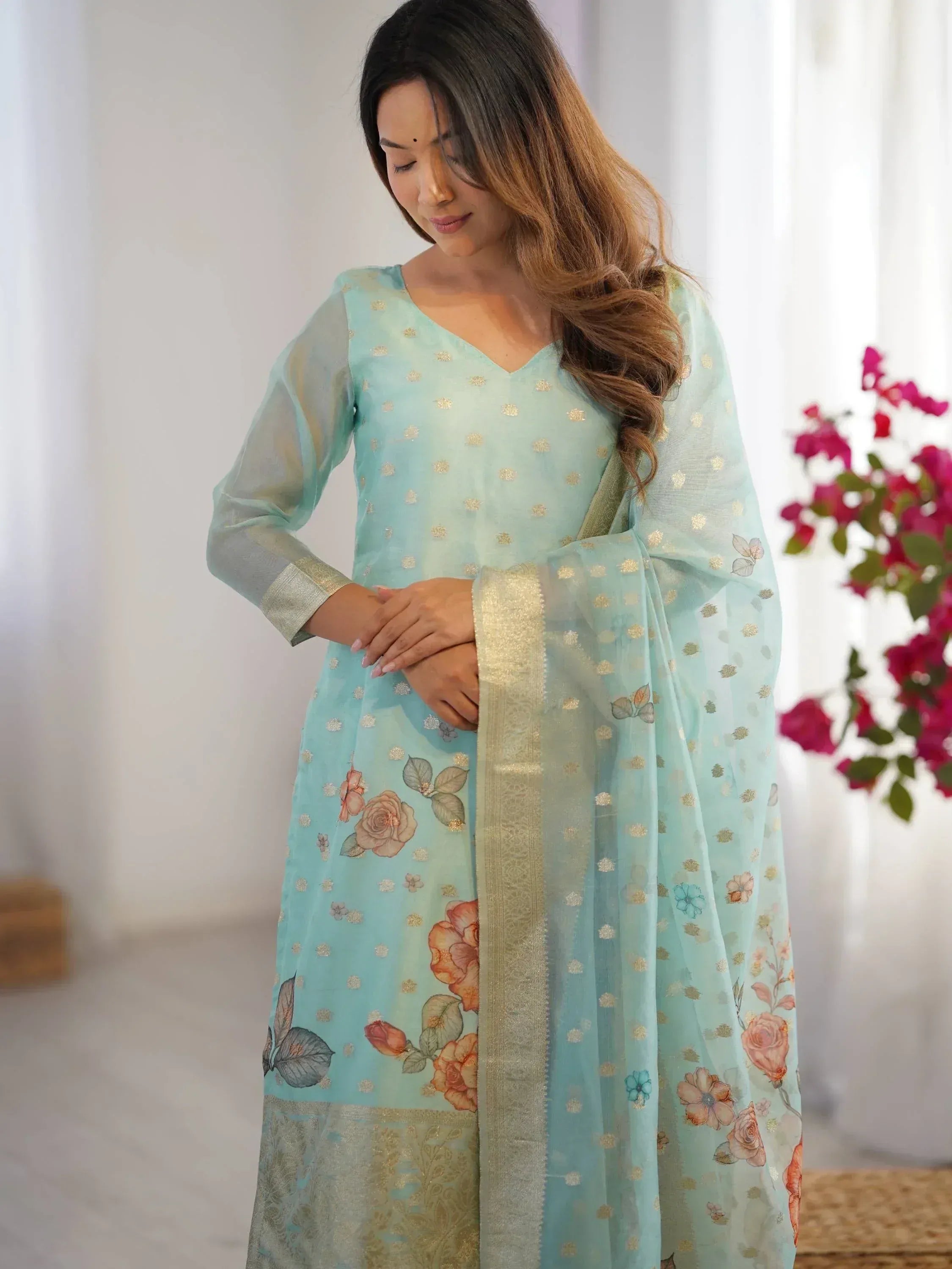 Light blue floral printed salwar kameez with gold embroidery and sheer dupatta, ethnic Indian wear
