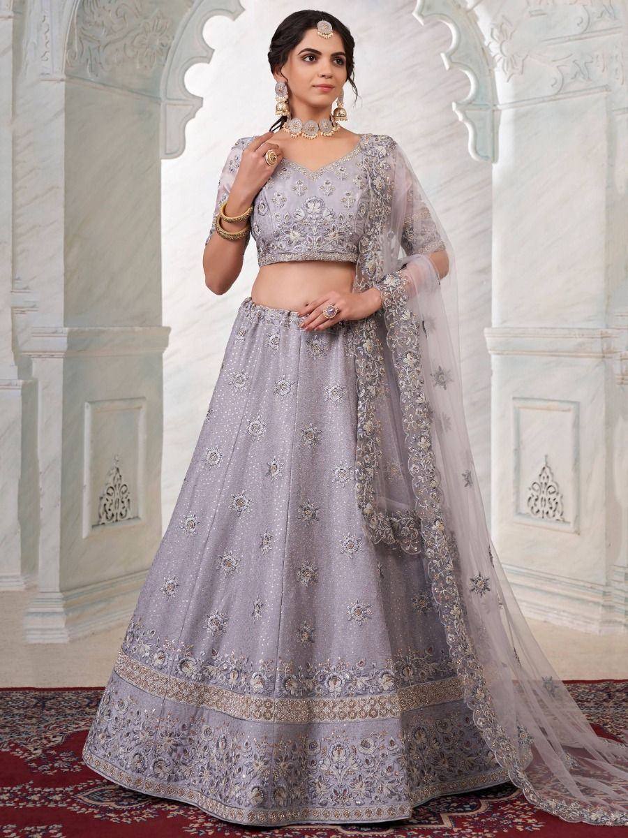 Elegant grey lehenga choli with intricate embroidery and sheer dupatta, perfect for Indian weddings and festive occasions.