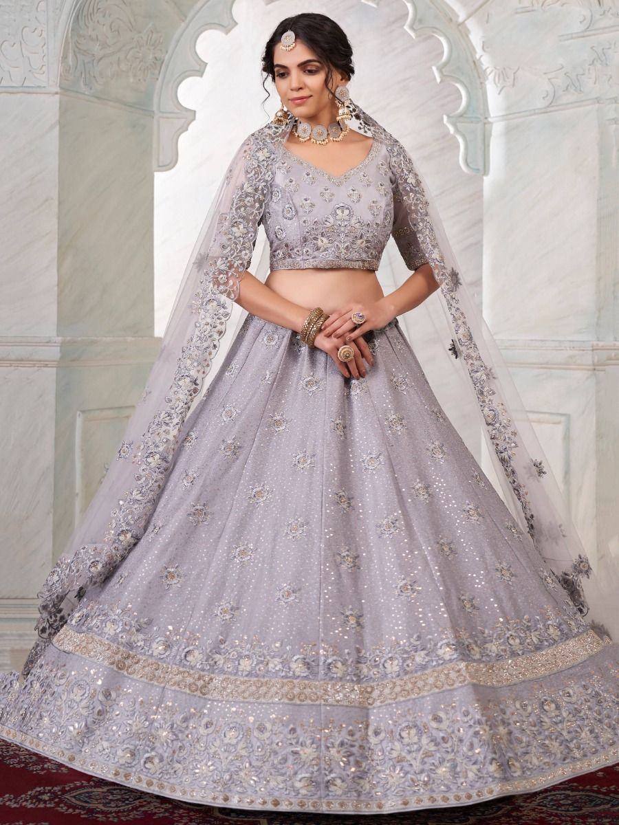 Elegant lavender designer lehenga choli with intricate embroidery and sheer dupatta for Indian weddings