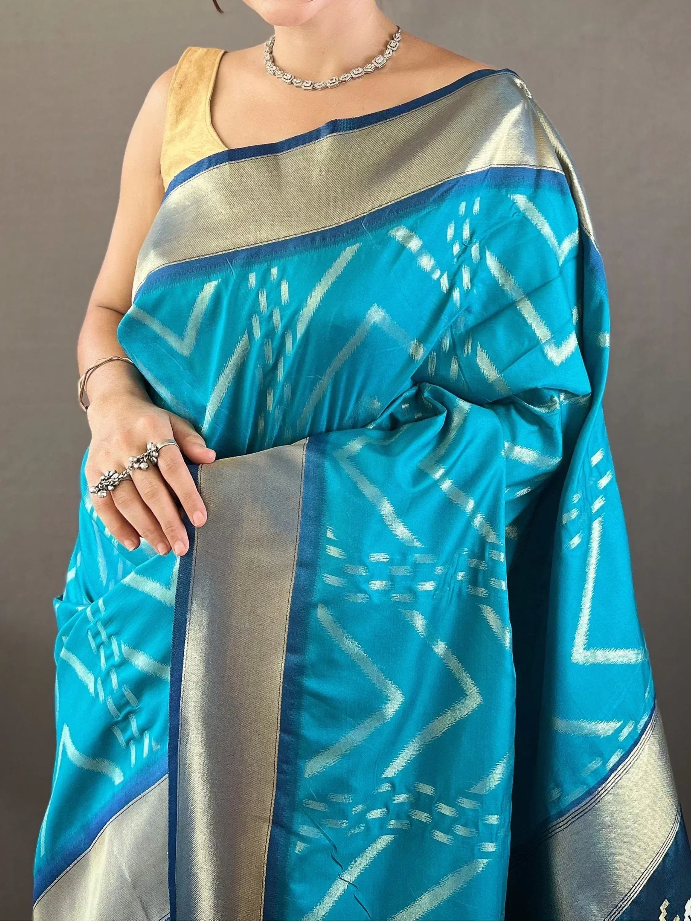 Turquoise ikat saree with silver zari border and gold blouse, ethnic Indian wear