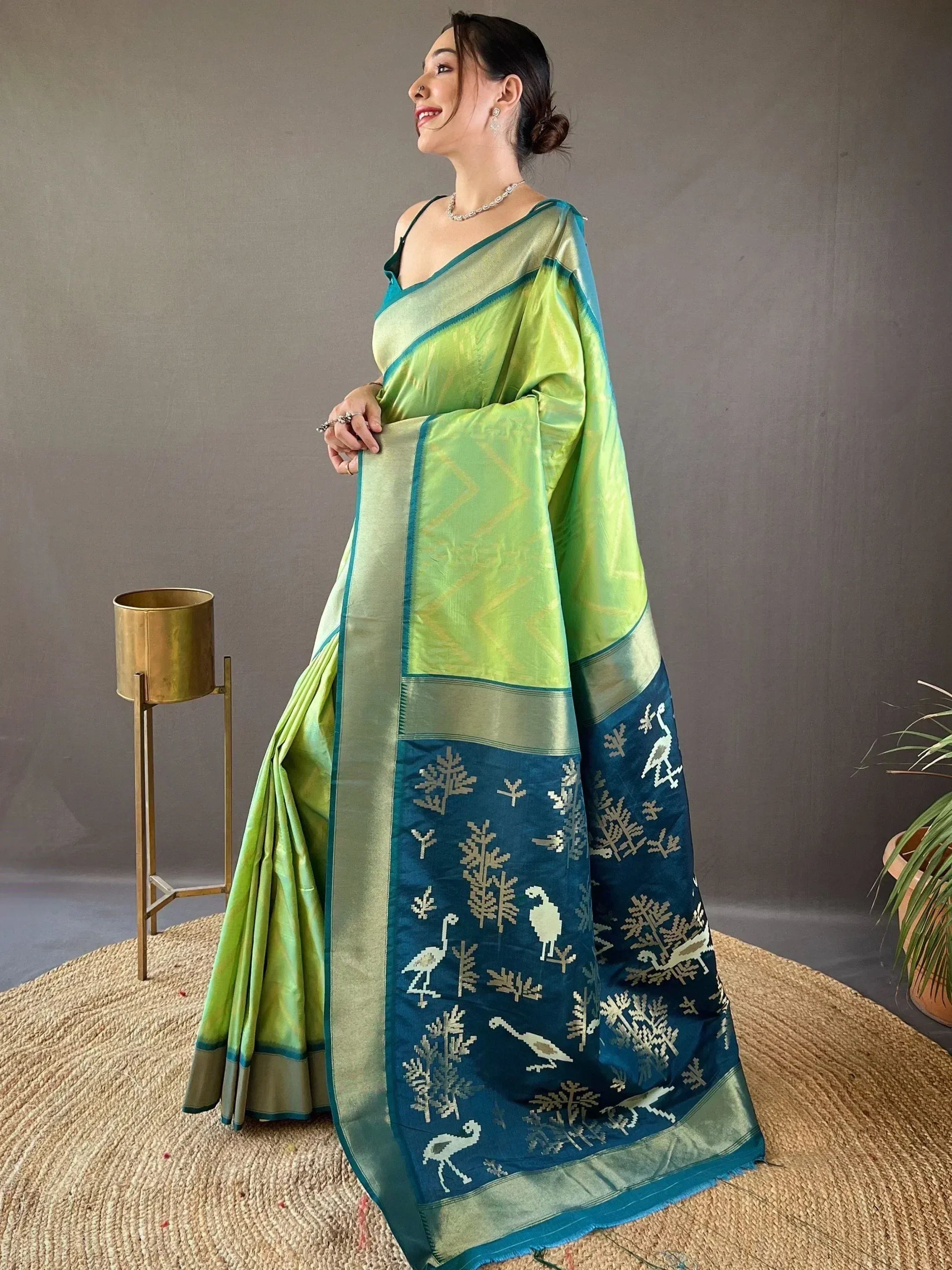 Green and blue ethnic saree with bird and tree motifs, perfect for Indian occasions