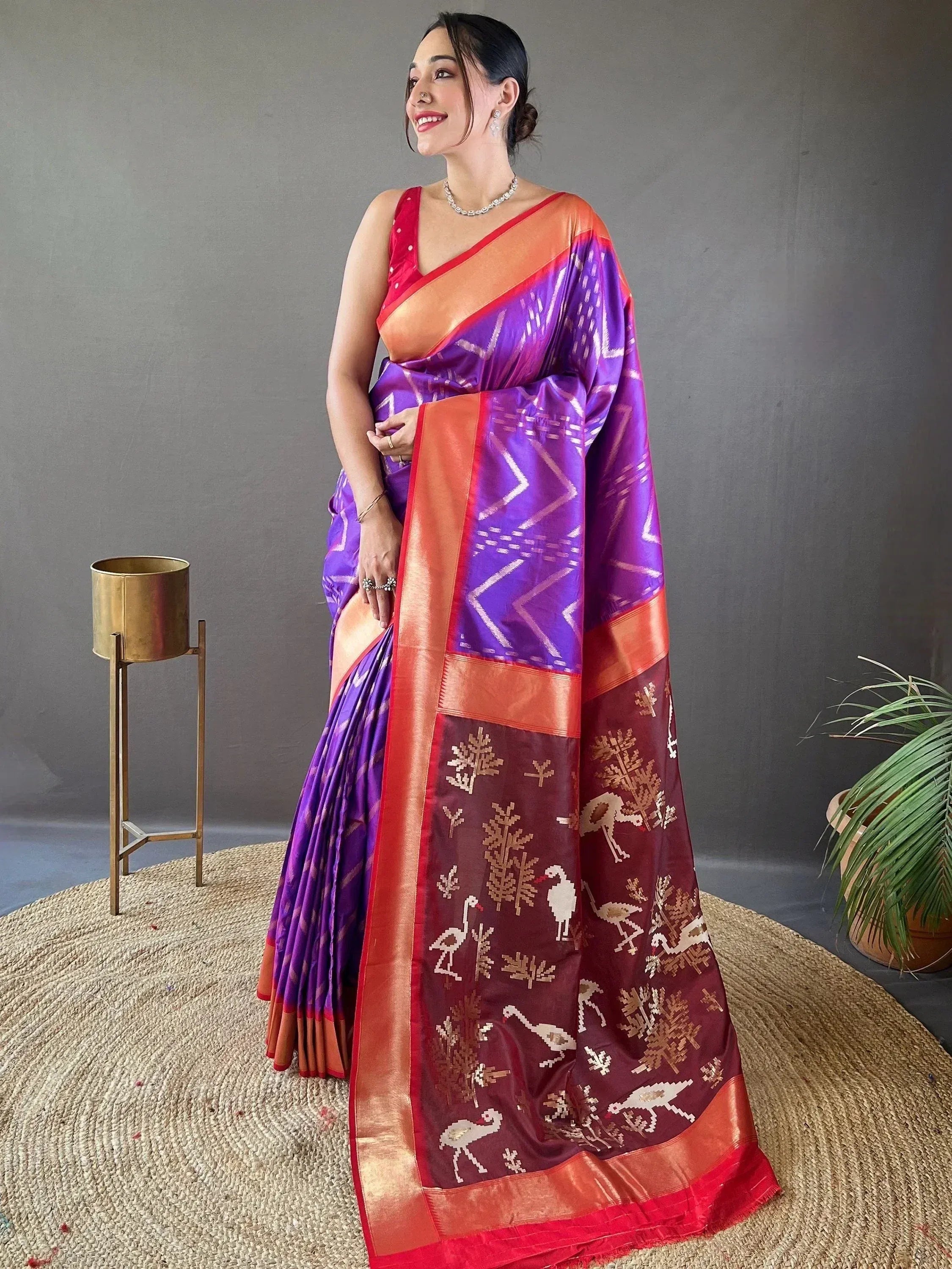 Woman in purple and maroon ikat saree with bird motifs, ethnic Indian wear