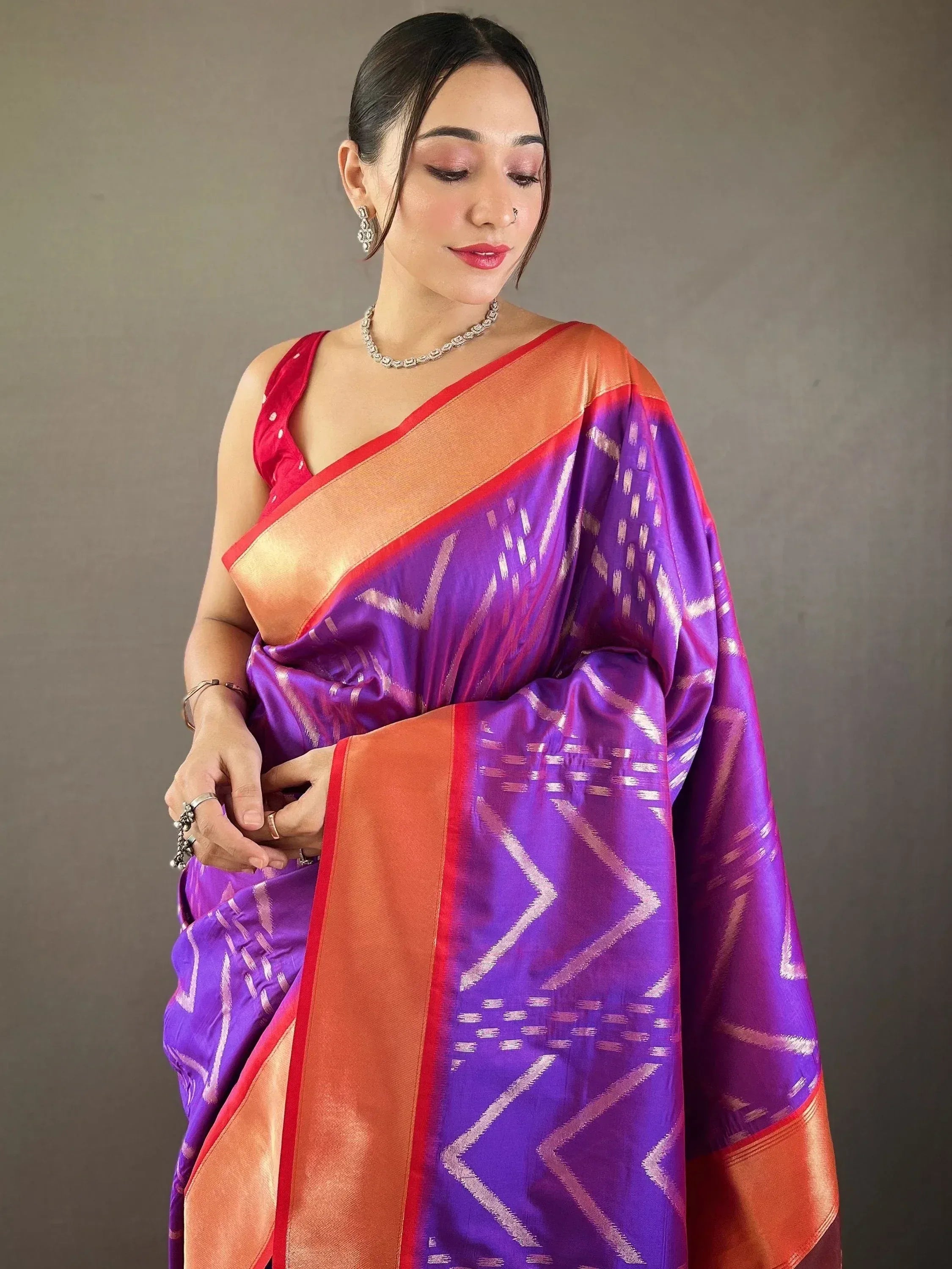 Purple and orange Ikat saree with geometric pattern, styled with red blouse for Indian ethnic wear