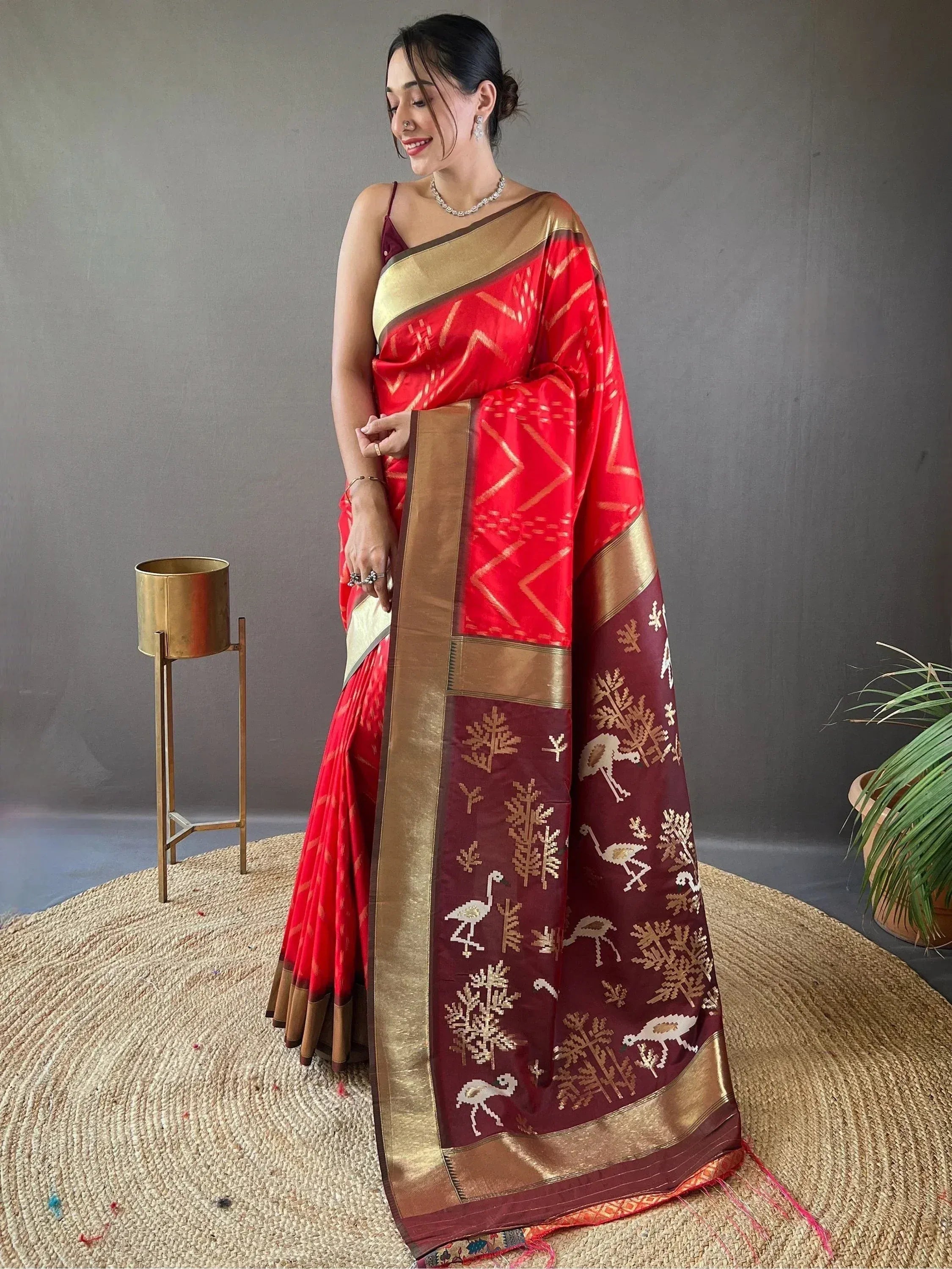 Red and maroon ethnic saree with gold bird and tree motifs, perfect for Indian occasions