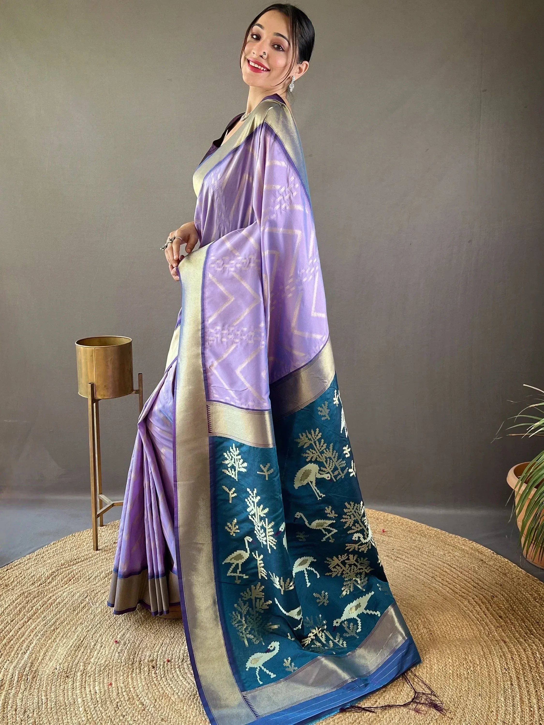 Purple and teal designer saree with gold bird and tree motifs, perfect for ethnic occasions