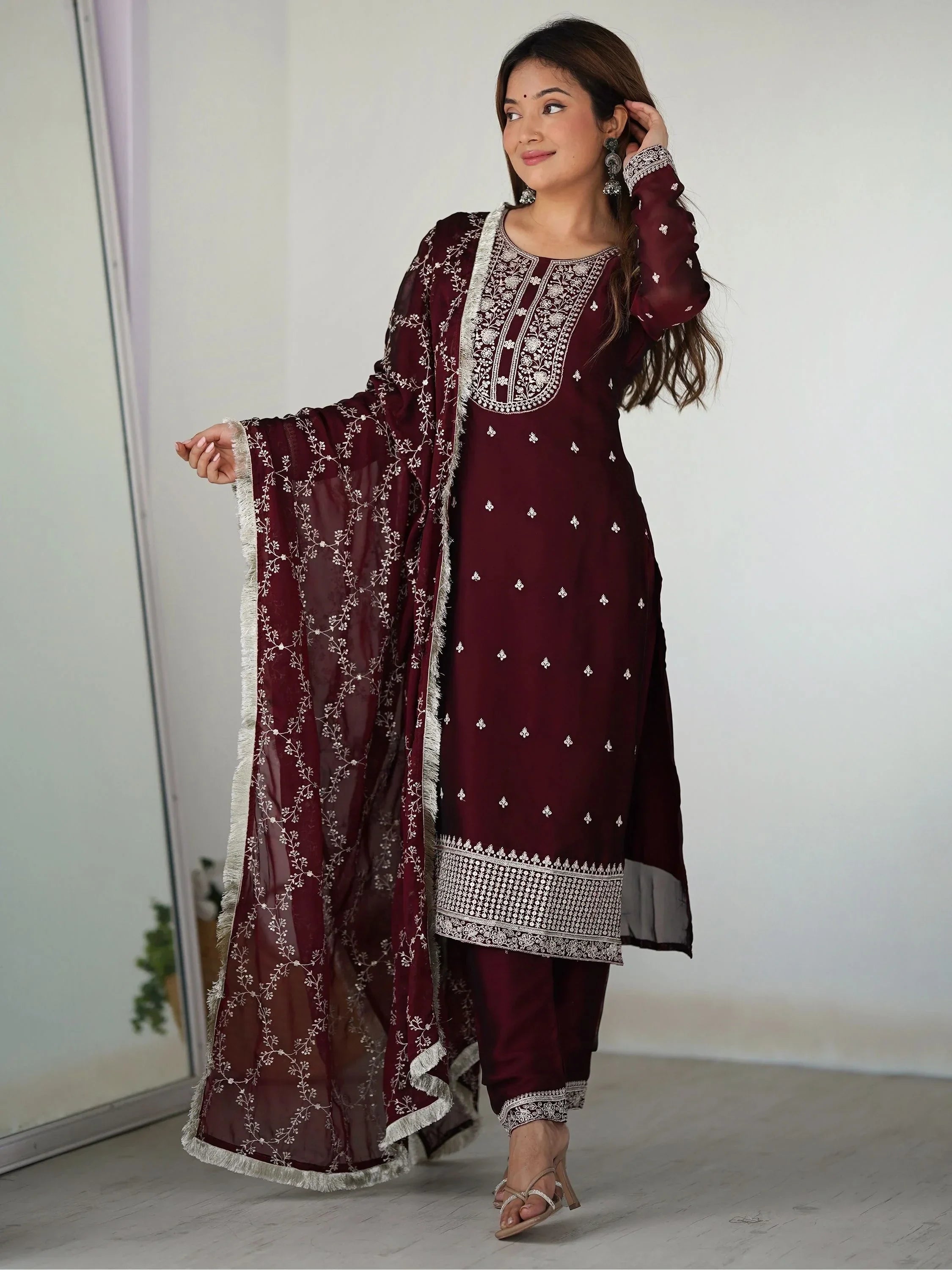 Woman in maroon embroidered salwar kameez with matching dupatta, stylish ethnic wear