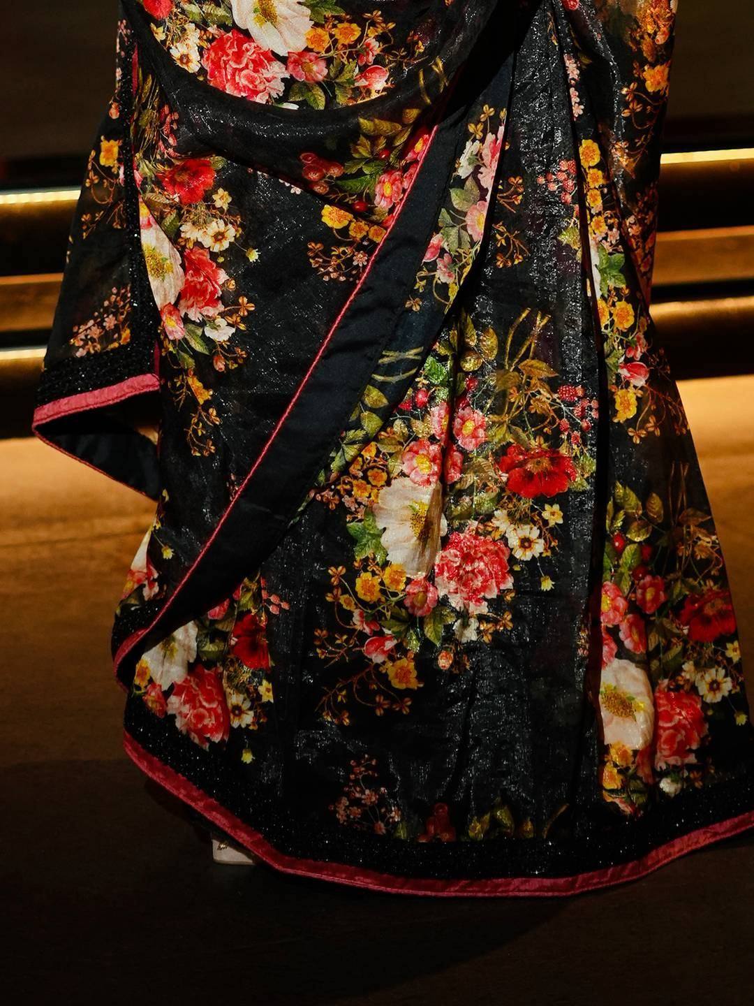 Black floral saree with red border, vibrant Indian ethnic wear for women