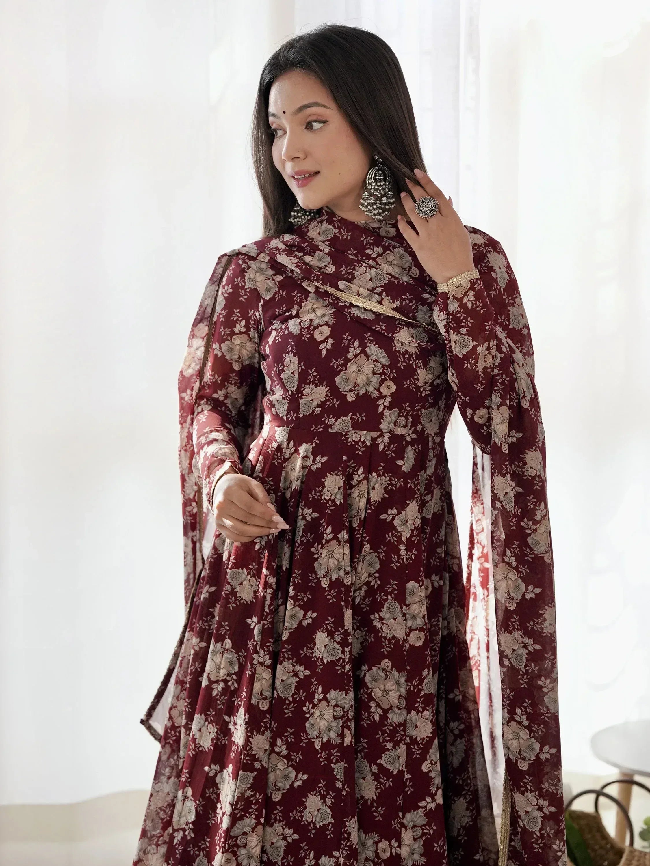 Maroon floral printed ethnic gown with cape sleeves, perfect for Indian occasions and festive wear.