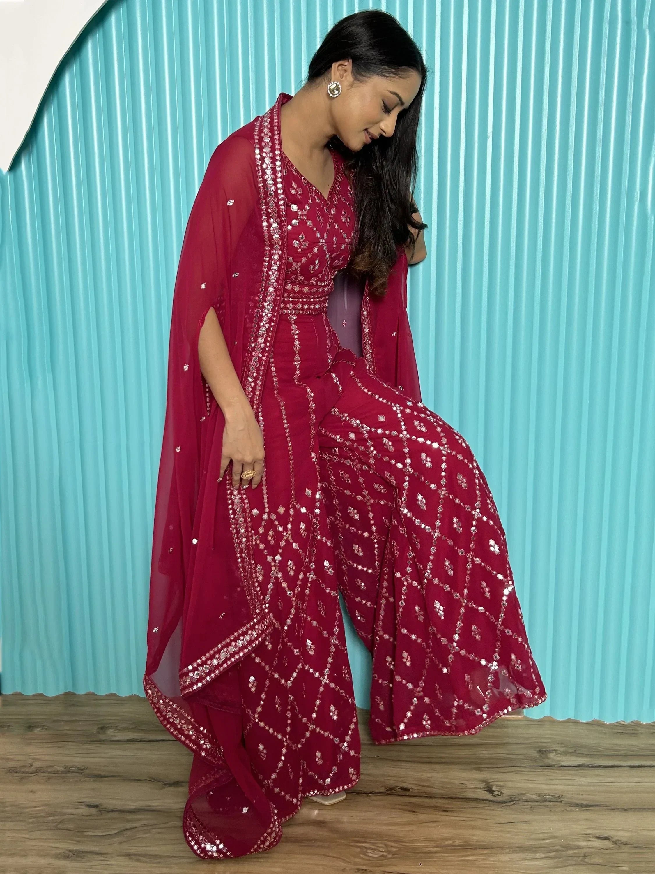 Woman in traditional maroon bandhani salwar kameez with dupatta, ethnic Indian wear