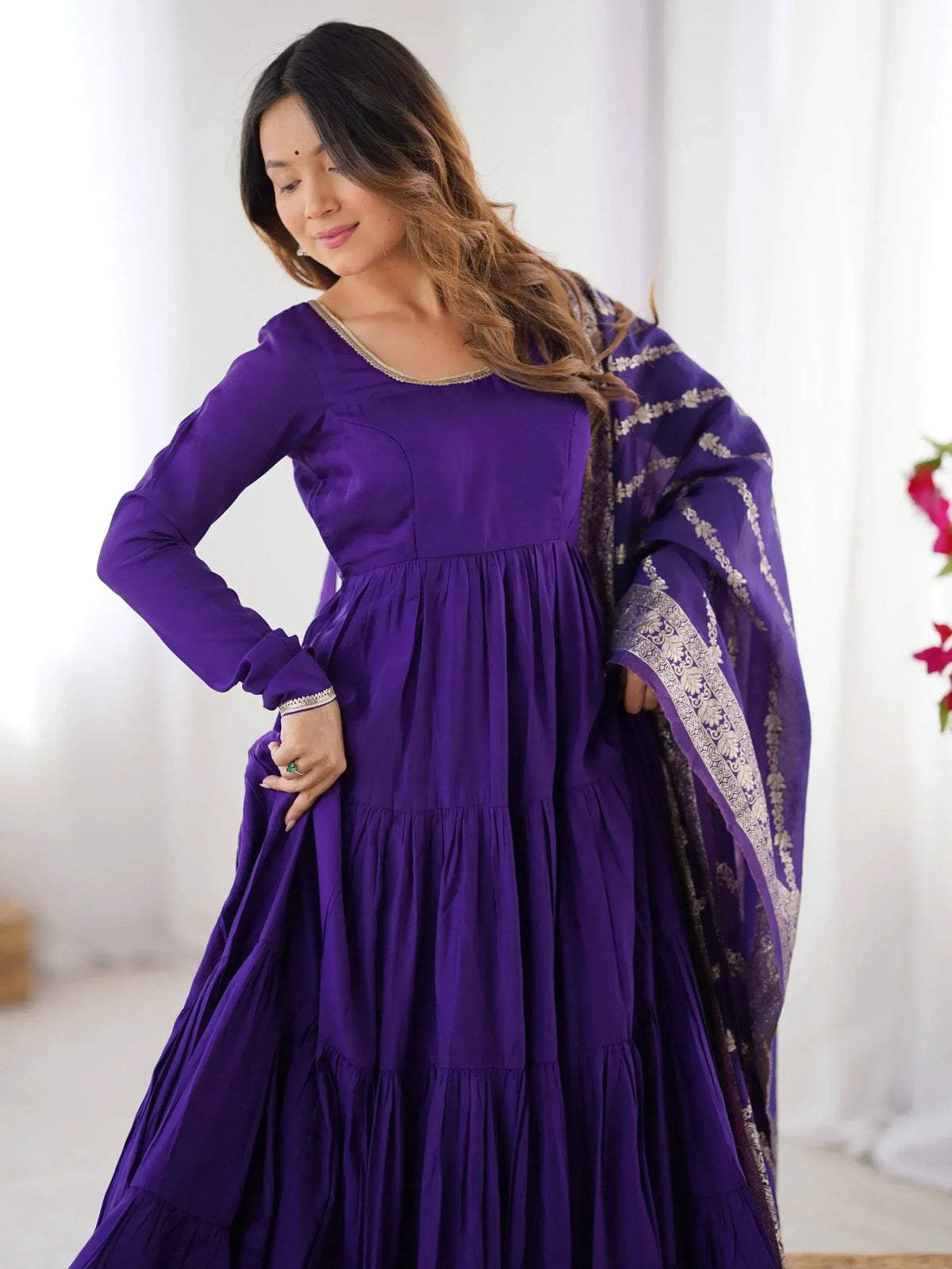Purple ethnic gown with gold trim and matching dupatta, ideal for Indian occasions