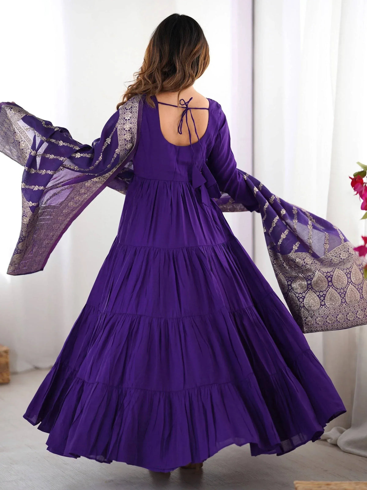 Purple tiered ethnic gown with bell sleeves and gold embroidery, back view