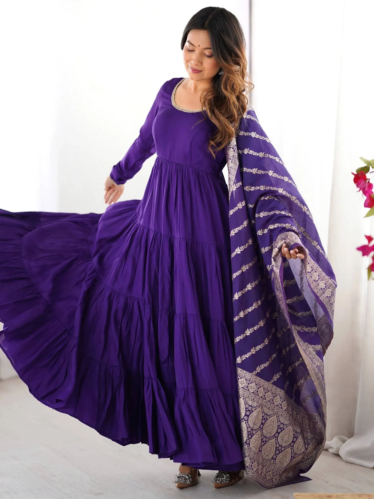 Purple tiered ethnic gown with gold embroidery dupatta, perfect for Indian festive occasions