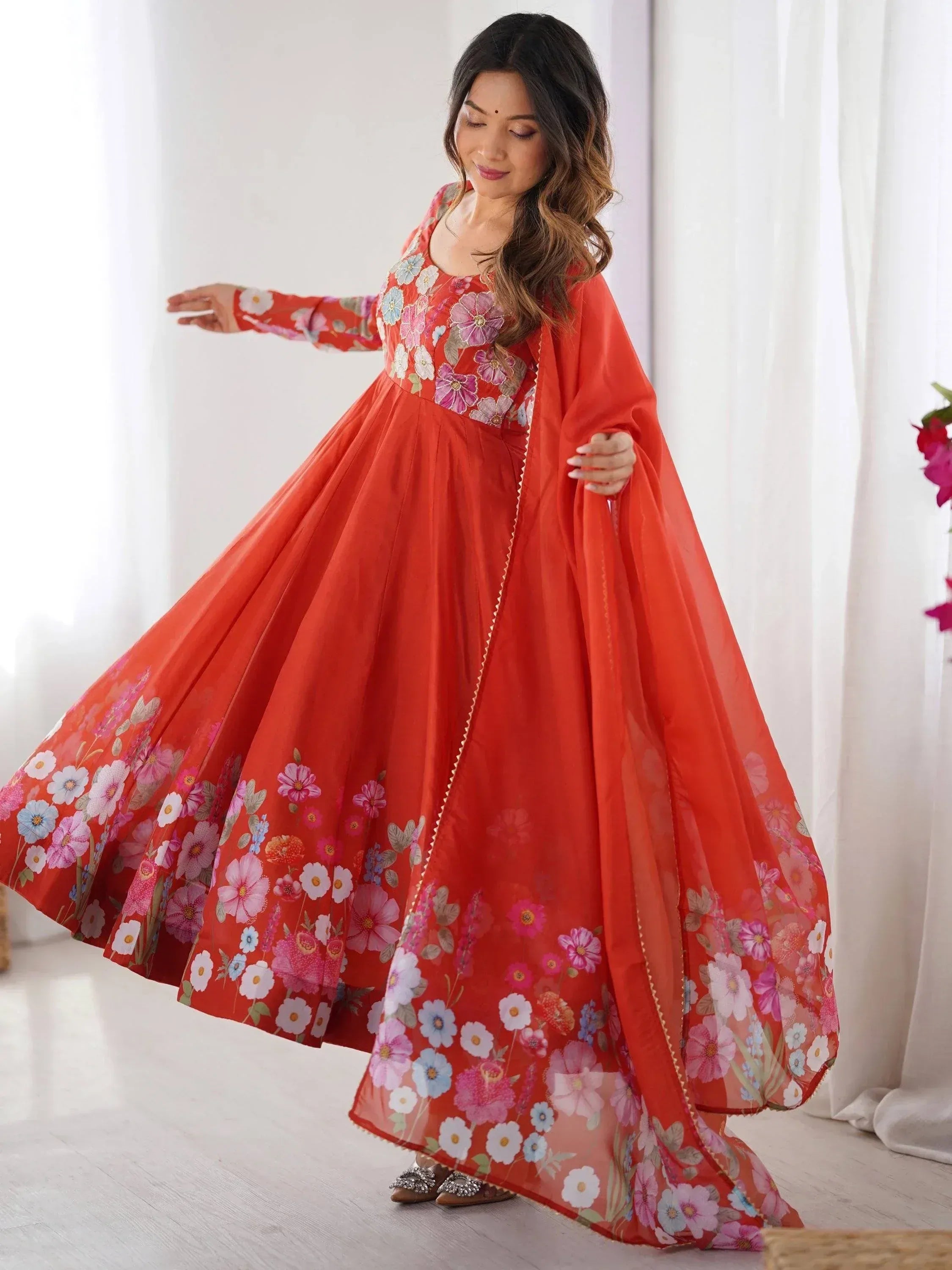 Orange floral print ethnic gown with cape, perfect for Indian occasions and festive wear
