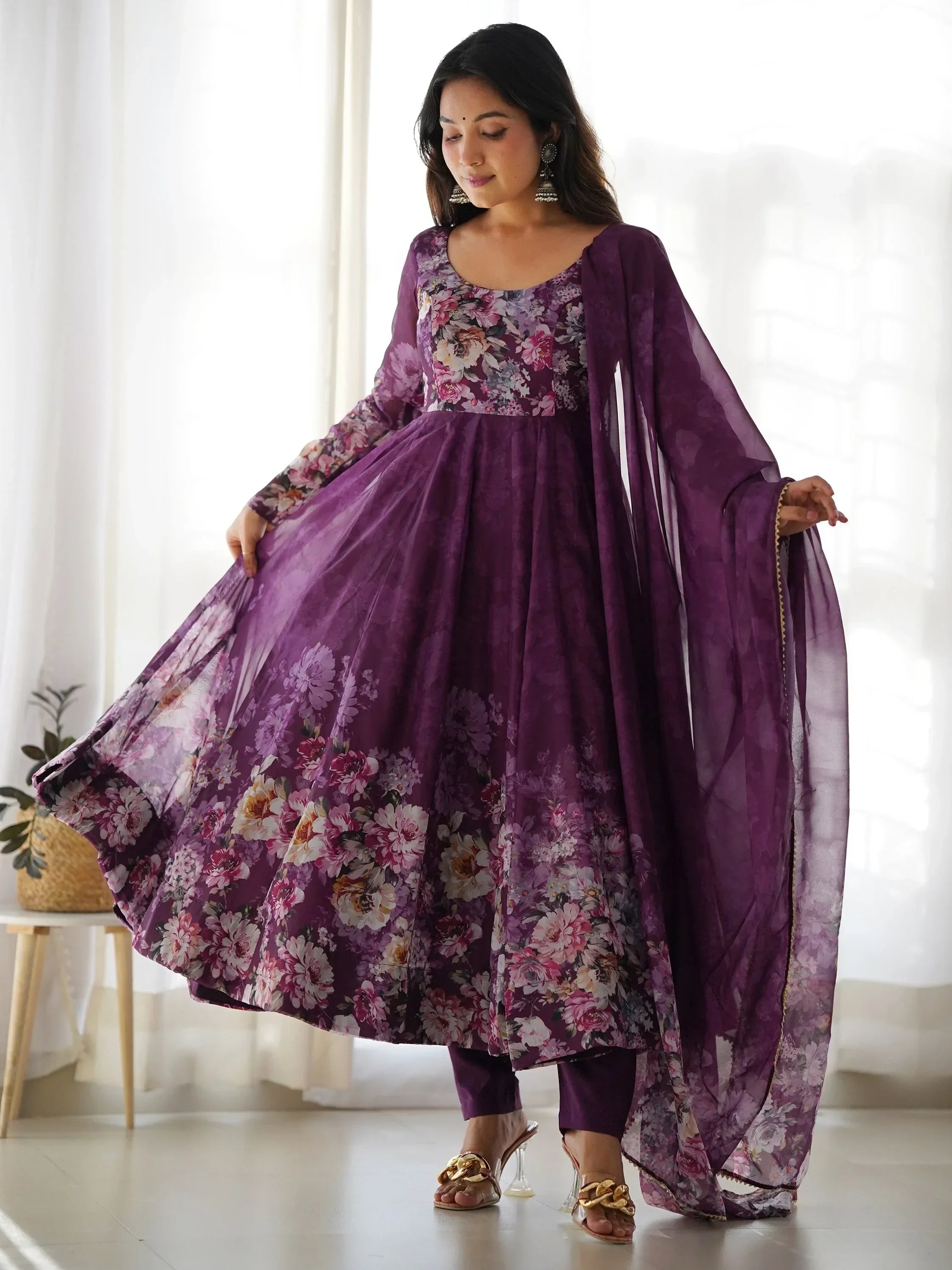 Woman in a purple floral Anarkali suit with dupatta, traditional Indian ethnic wear