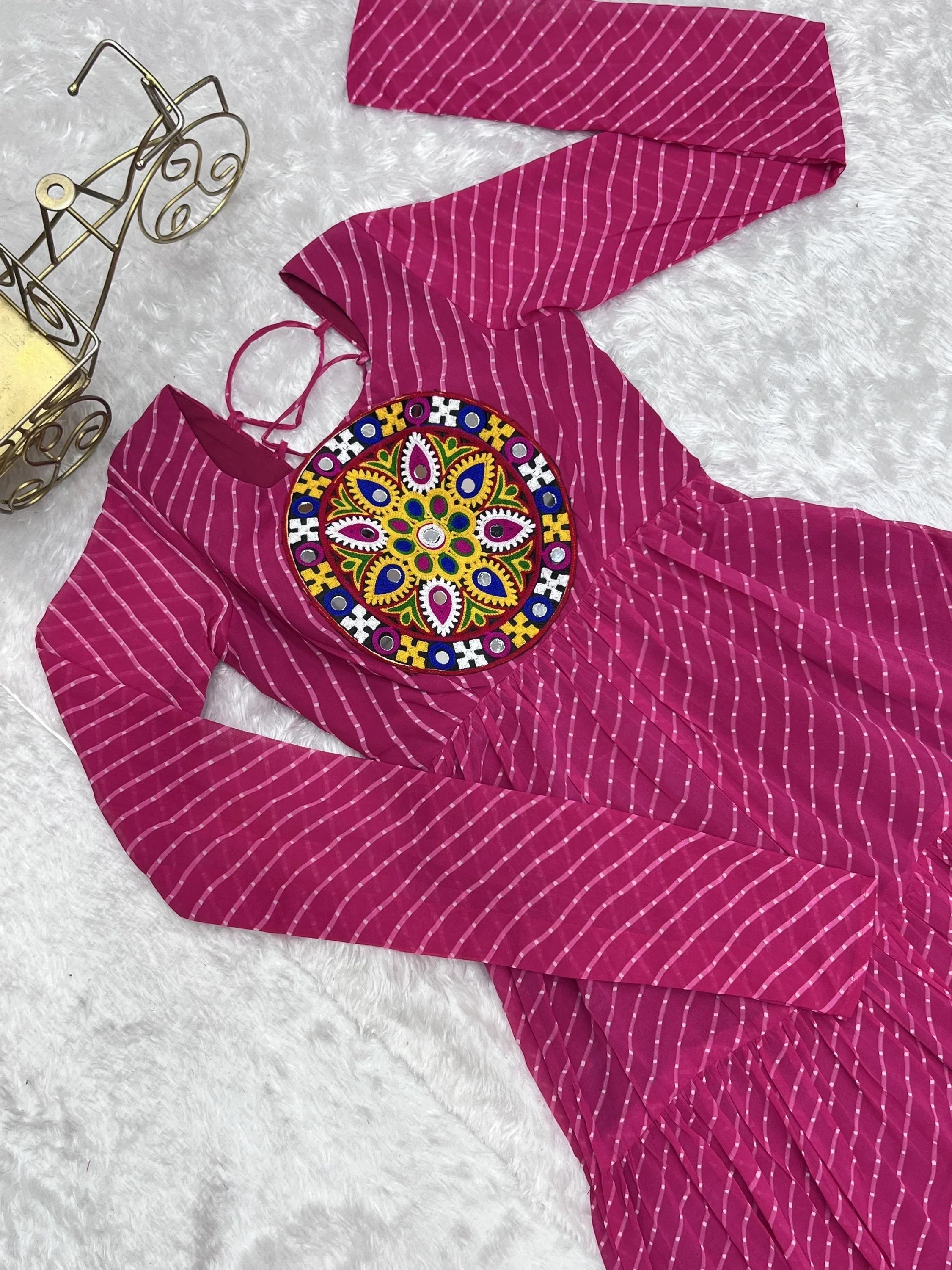 Pink ethnic gown with white stripes and colorful embroidered round patch on chest