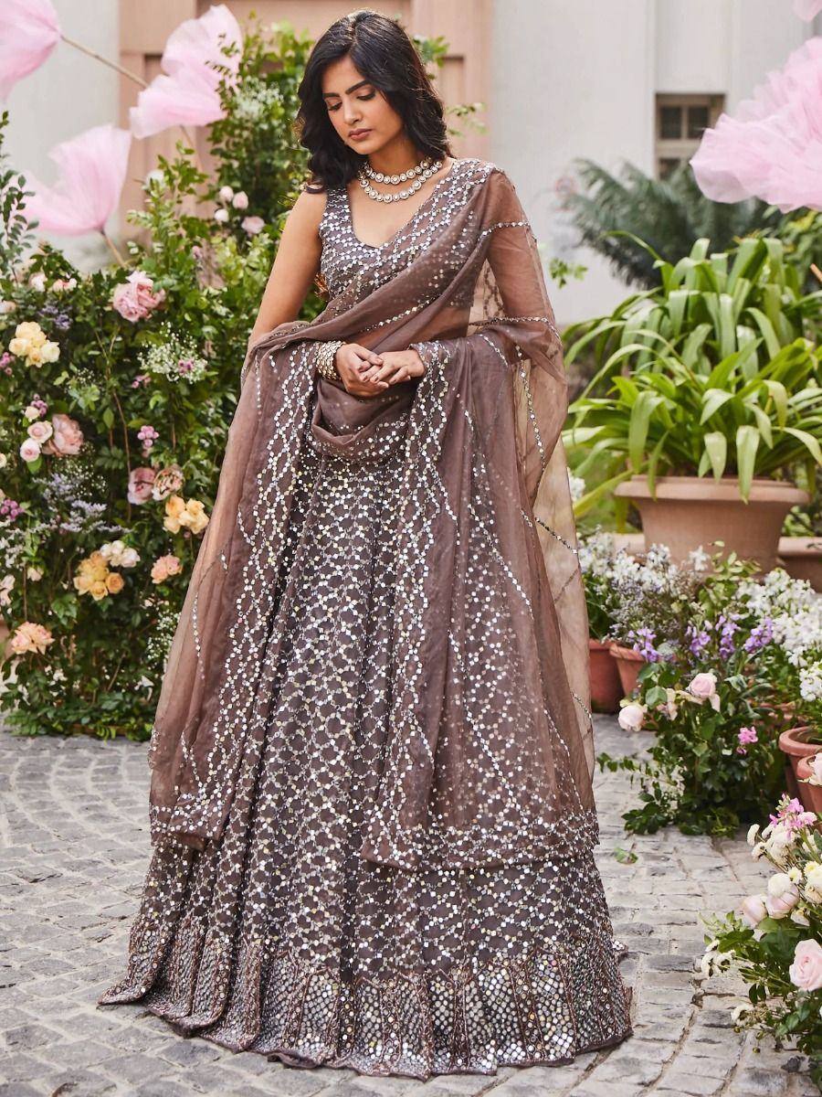 Brown mirror work lehenga choli with sheer dupatta, perfect for Indian ethnic wear events