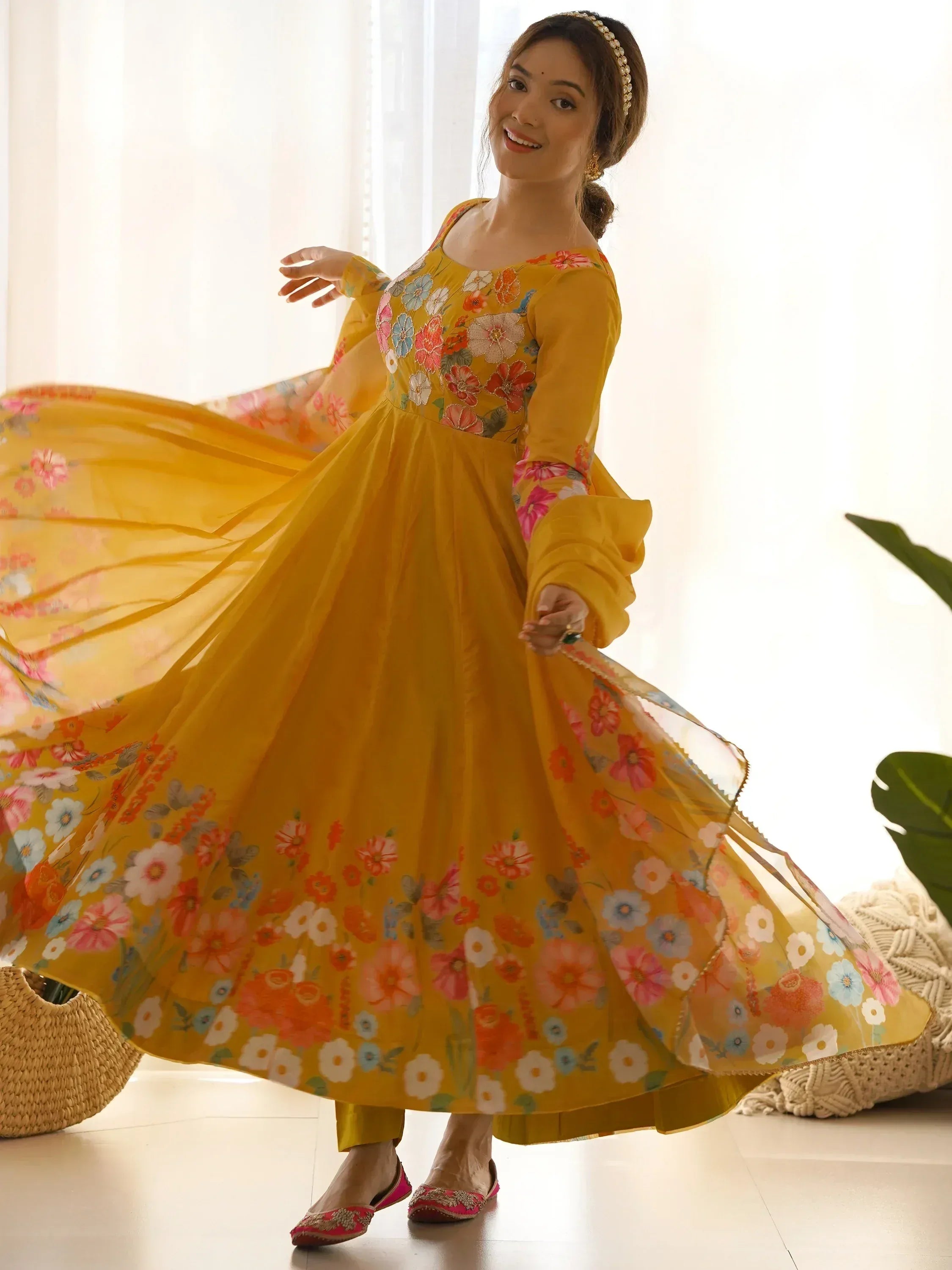 Yellow floral ethnic gown with flared sleeves, perfect for Indian occasions and festive wear.