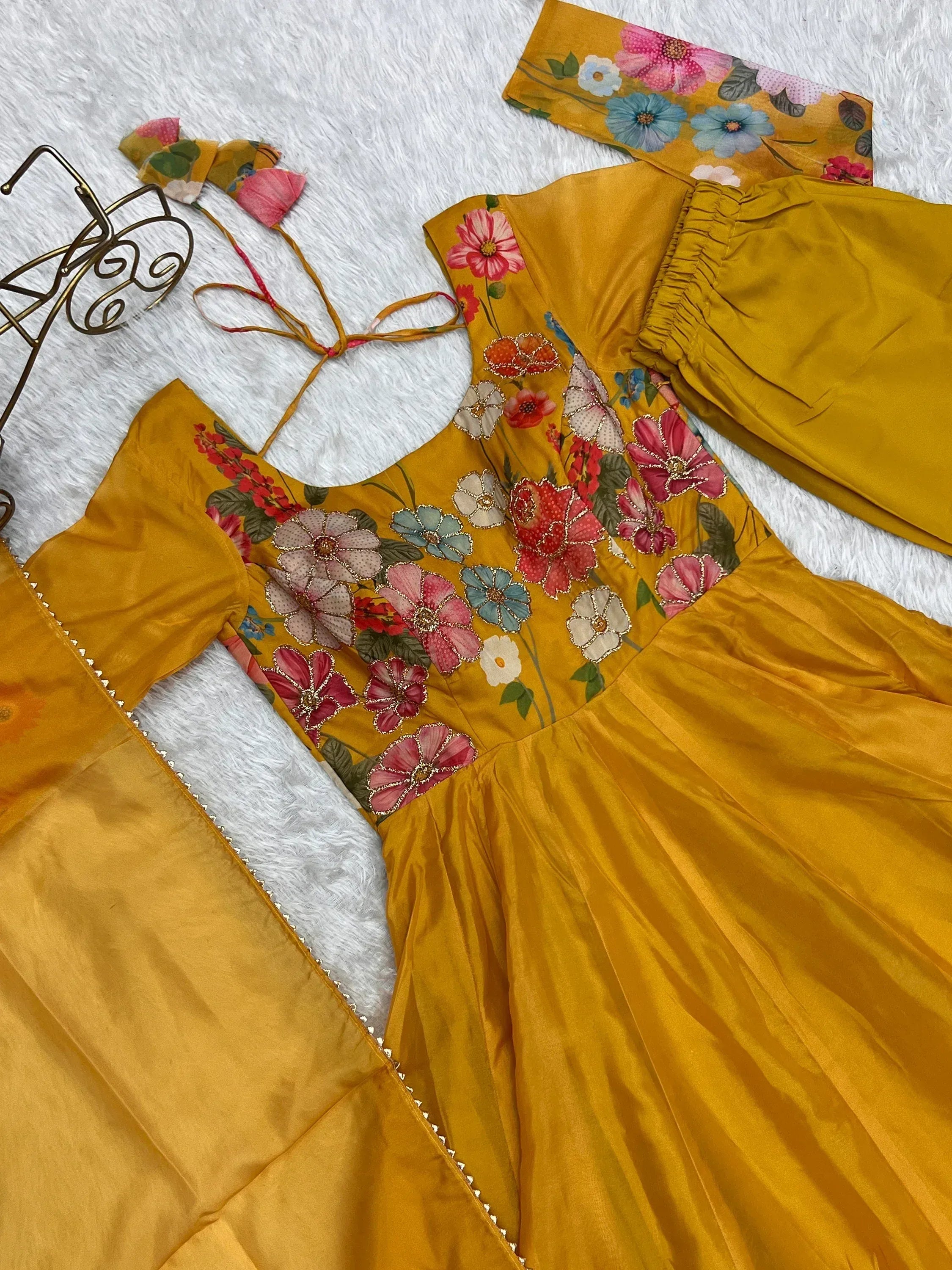 Yellow floral ethnic gown with vibrant embroidery, perfect for festive occasions.