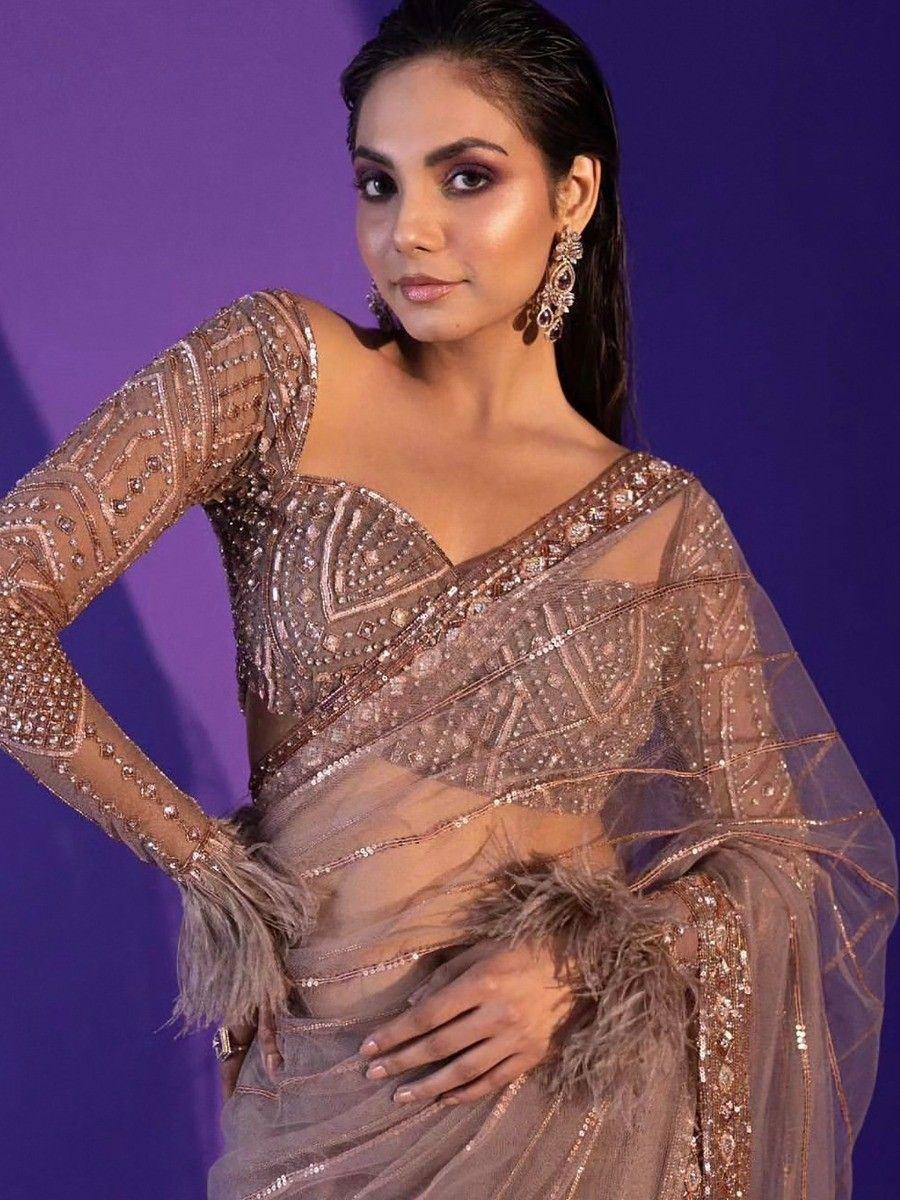 Elegant sheer saree with intricate beadwork and feather detailing, perfect for Indian ethnic events