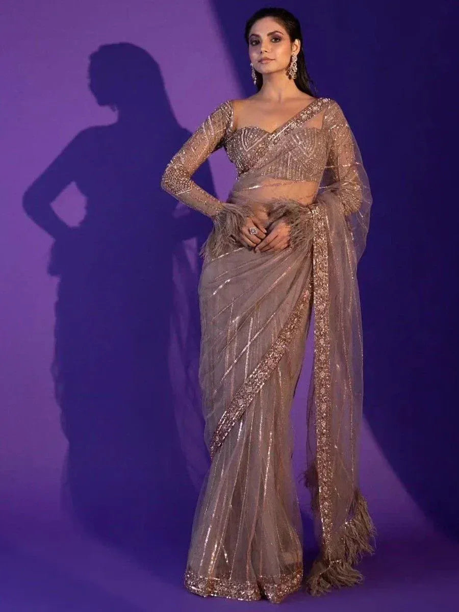 Elegant sequined saree with feathered border and matching blouse, perfect for Indian ethnic events
