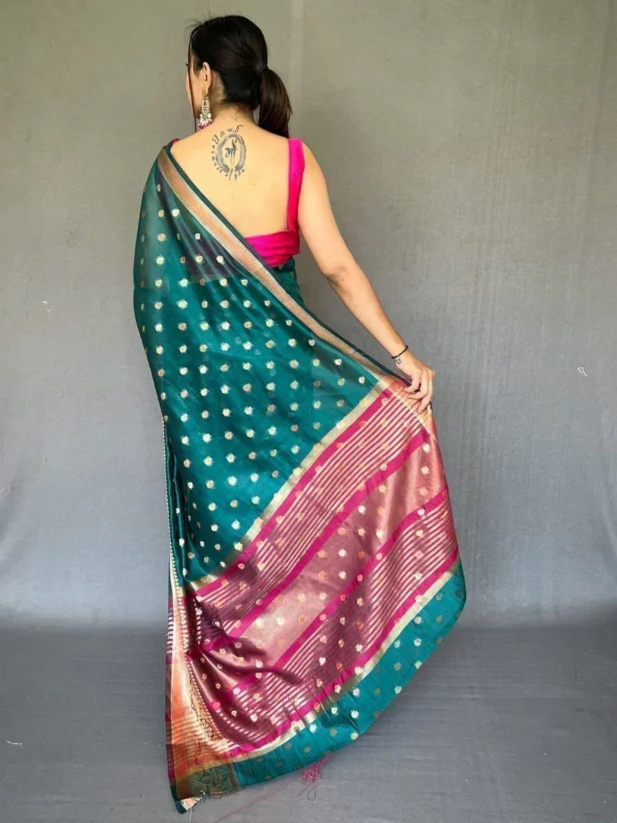 Teal silk saree with gold polka dots and pink border, paired with pink blouse, Indian ethnic wear