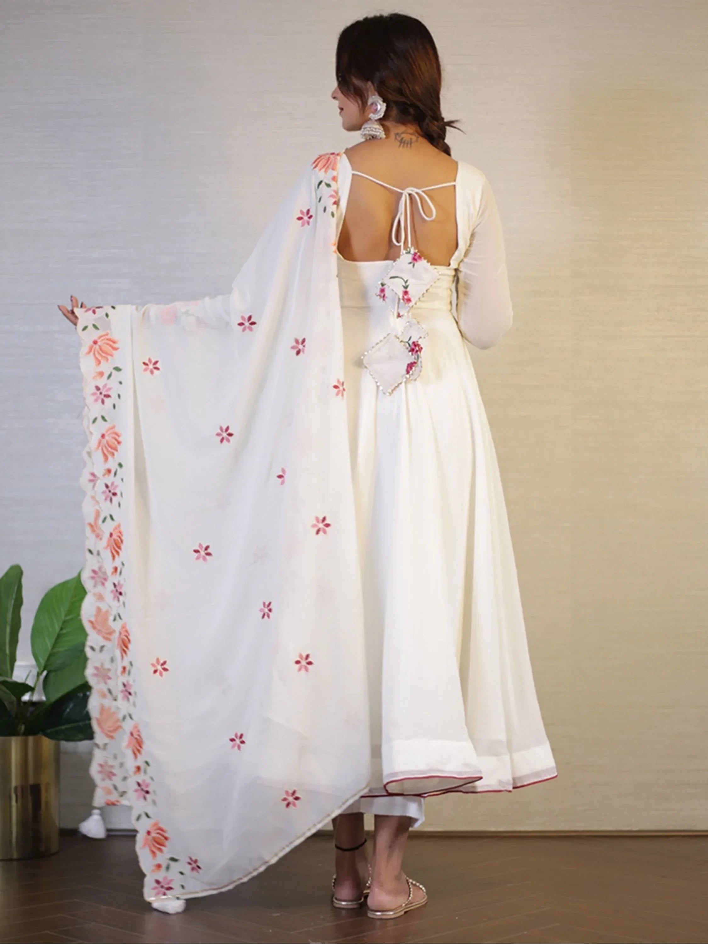 Woman in white Indian ethnic gown with floral embroidered dupatta and back tie detail