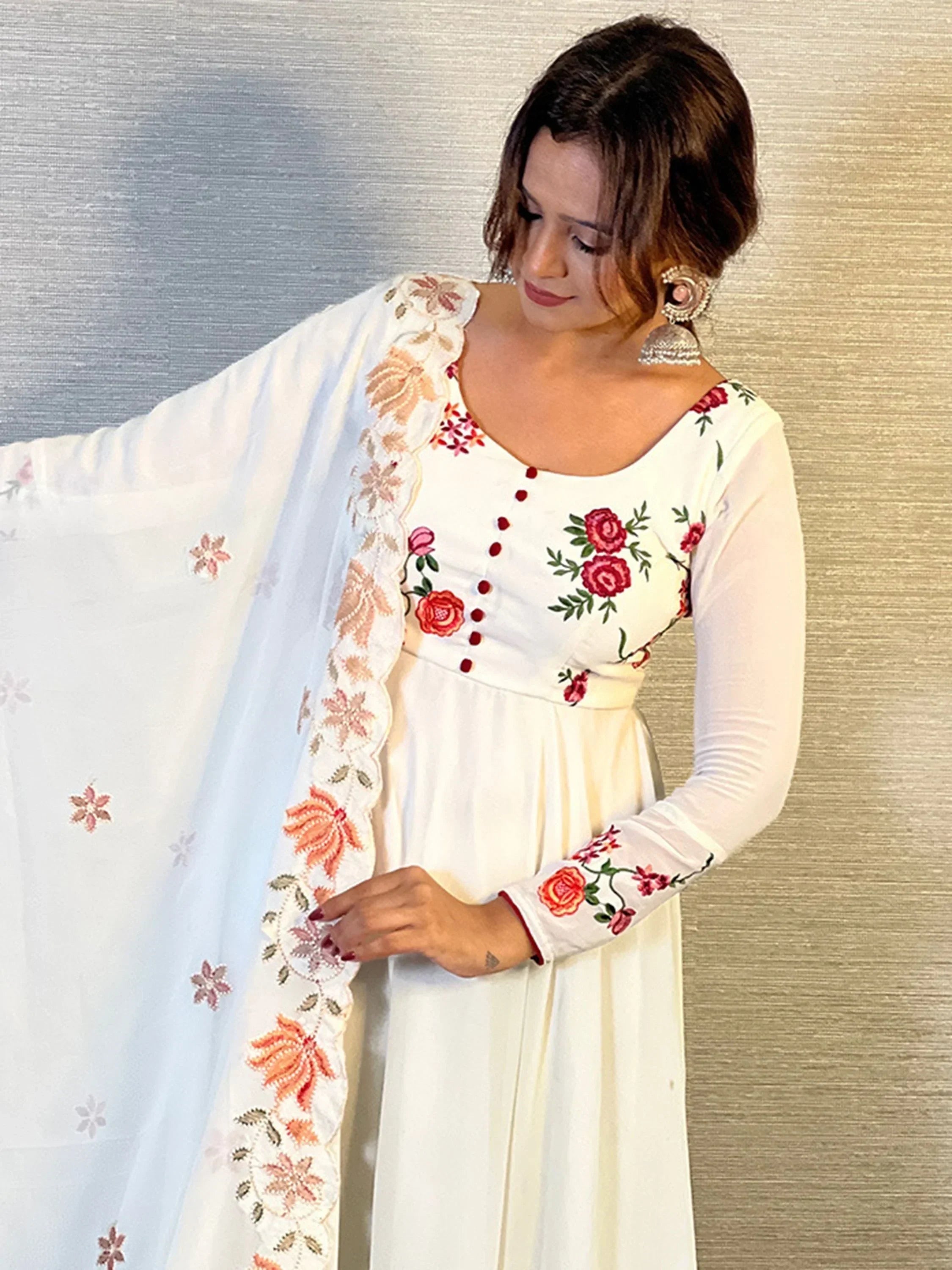 Woman in white embroidered Anarkali suit with floral dupatta, Indian ethnic wear