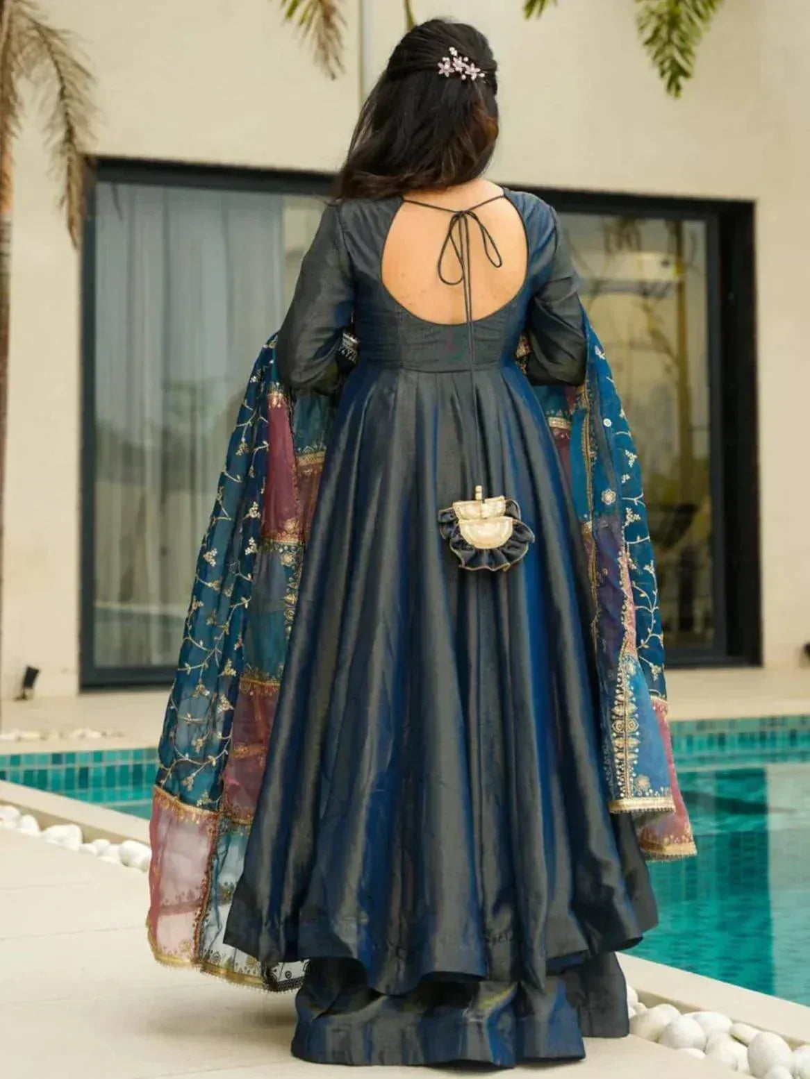 Blue designer anarkali gown with back tie, embroidered dupatta, poolside setting