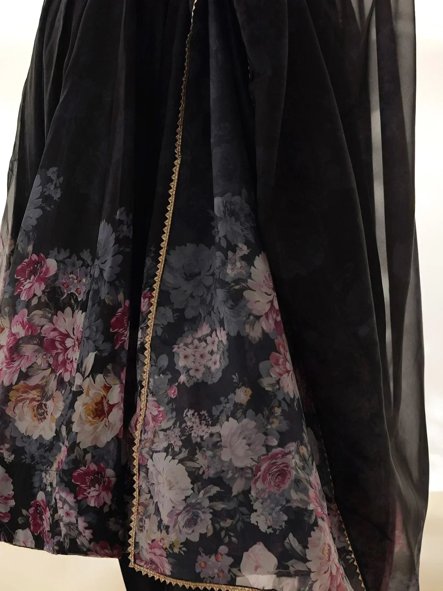 Black velvet ethnic gown with floral print and gold trim, perfect for Indian occasions