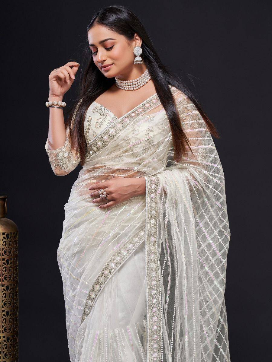 Elegant white embroidered saree with sheer blouse, perfect for Indian ethnic wear and festive occasions