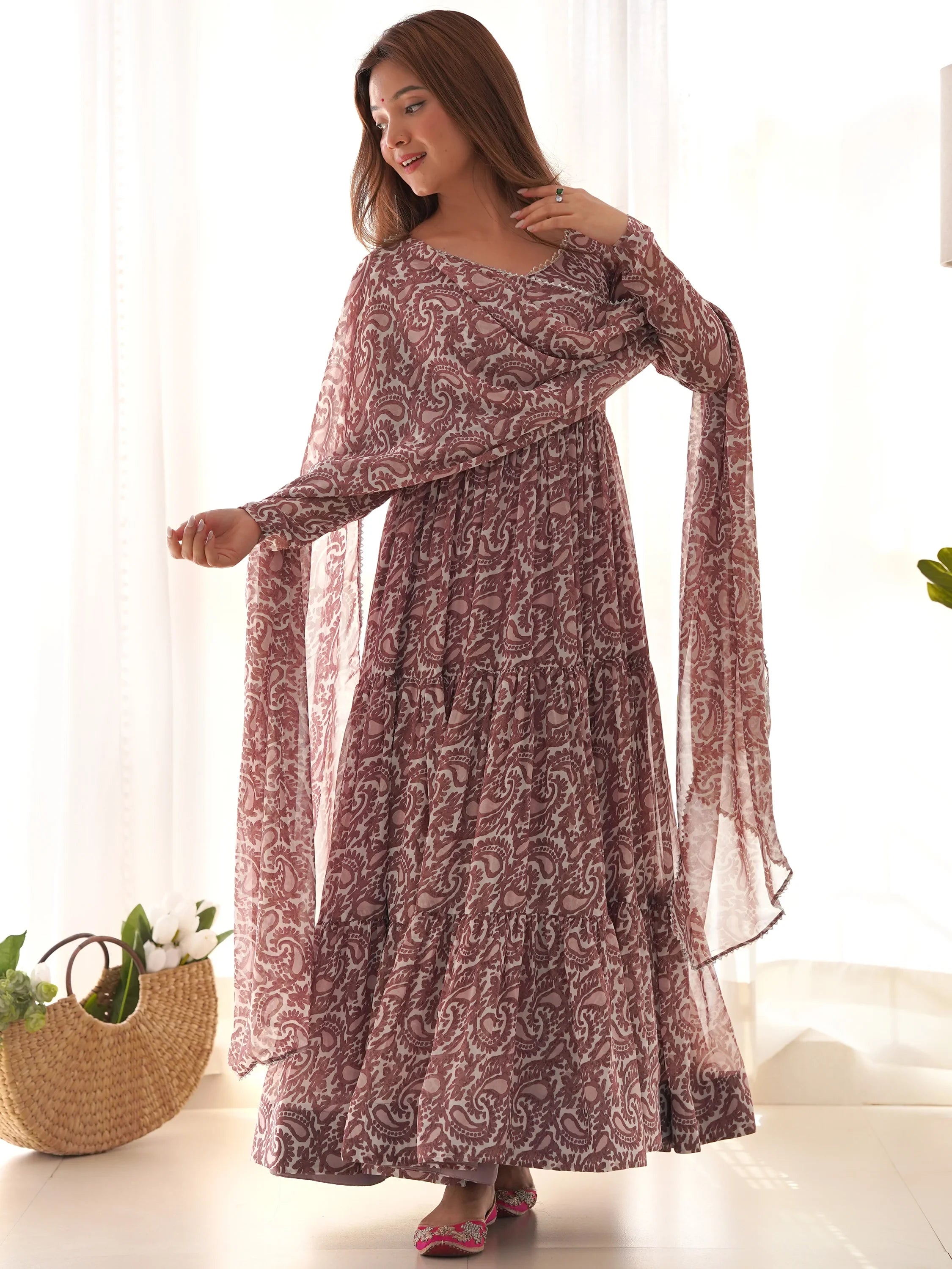 Woman in maroon paisley print ethnic gown with dupatta, traditional Indian attire