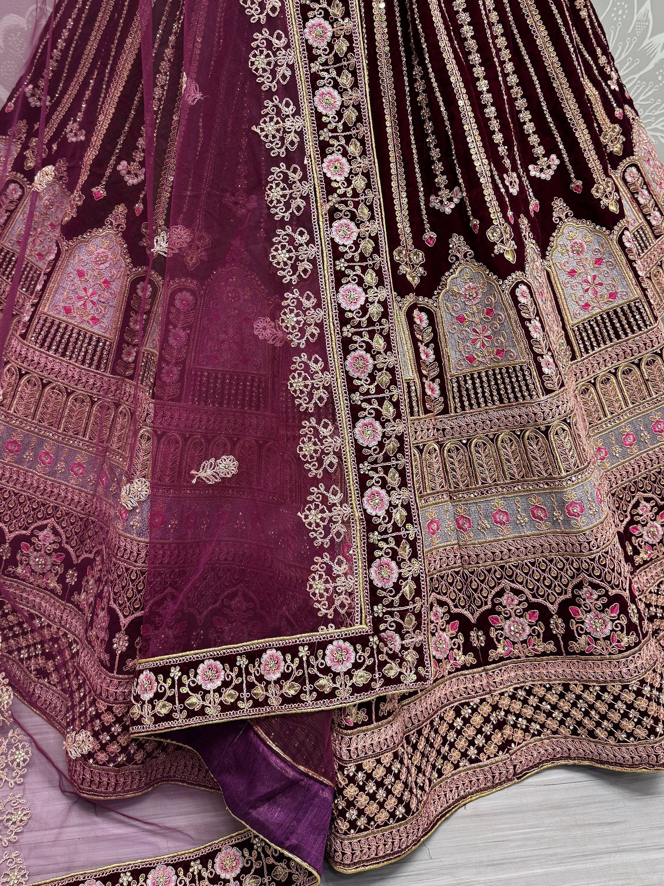 Elegant maroon lehenga with intricate gold and pink floral embroidery, perfect for Indian ethnic wear.